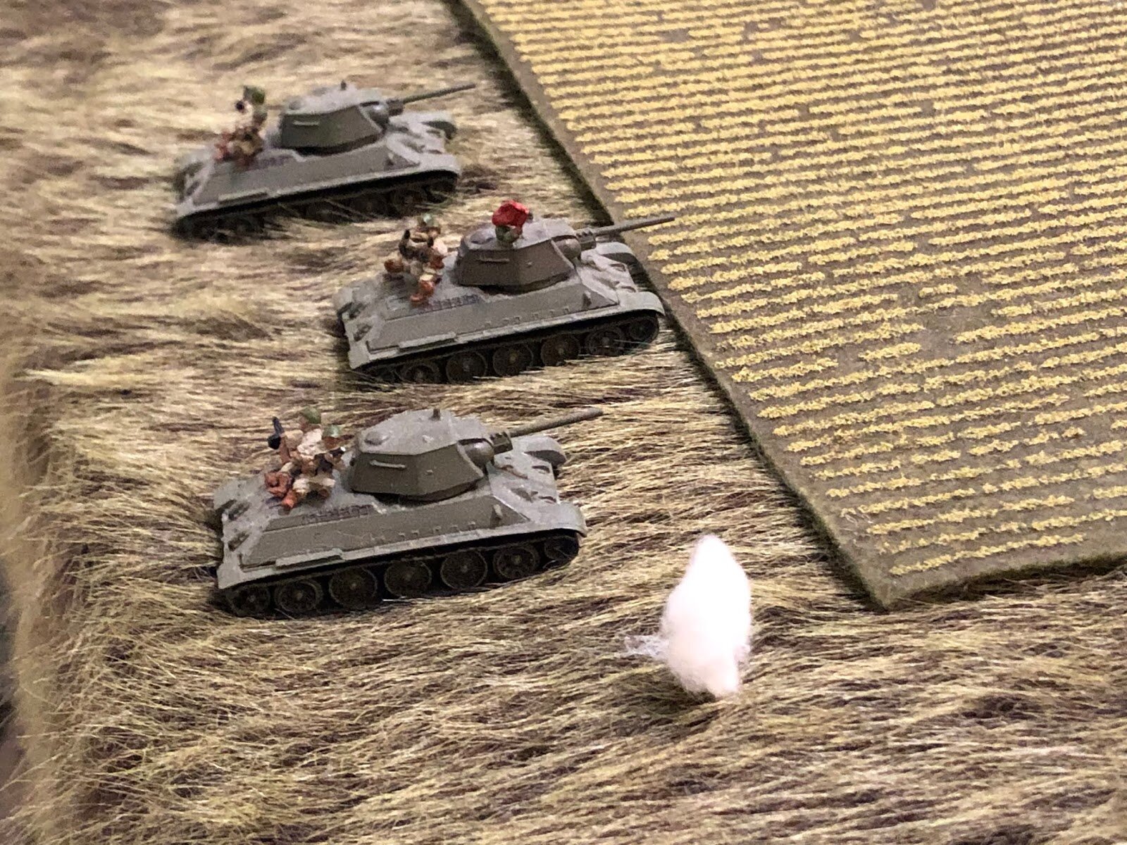  The 75mm round slams into the earth besides the Soviet 1st Tank Platoon, showering the hapless infantry riding on the back deck in large clods of dirt! 
