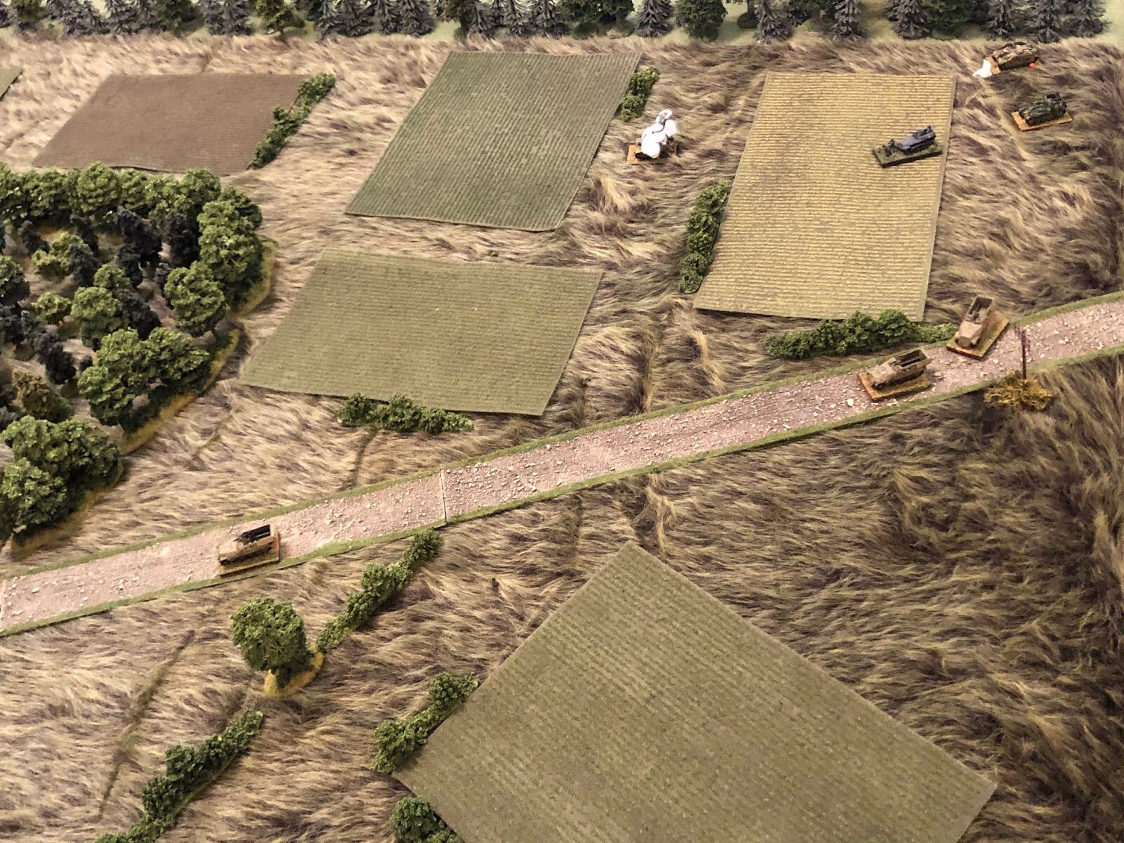  A little further south (the German armor is at top right), the German PC in the halftracks pushes up the road (far left, from right), though he has yet to spot any enemy forces. 