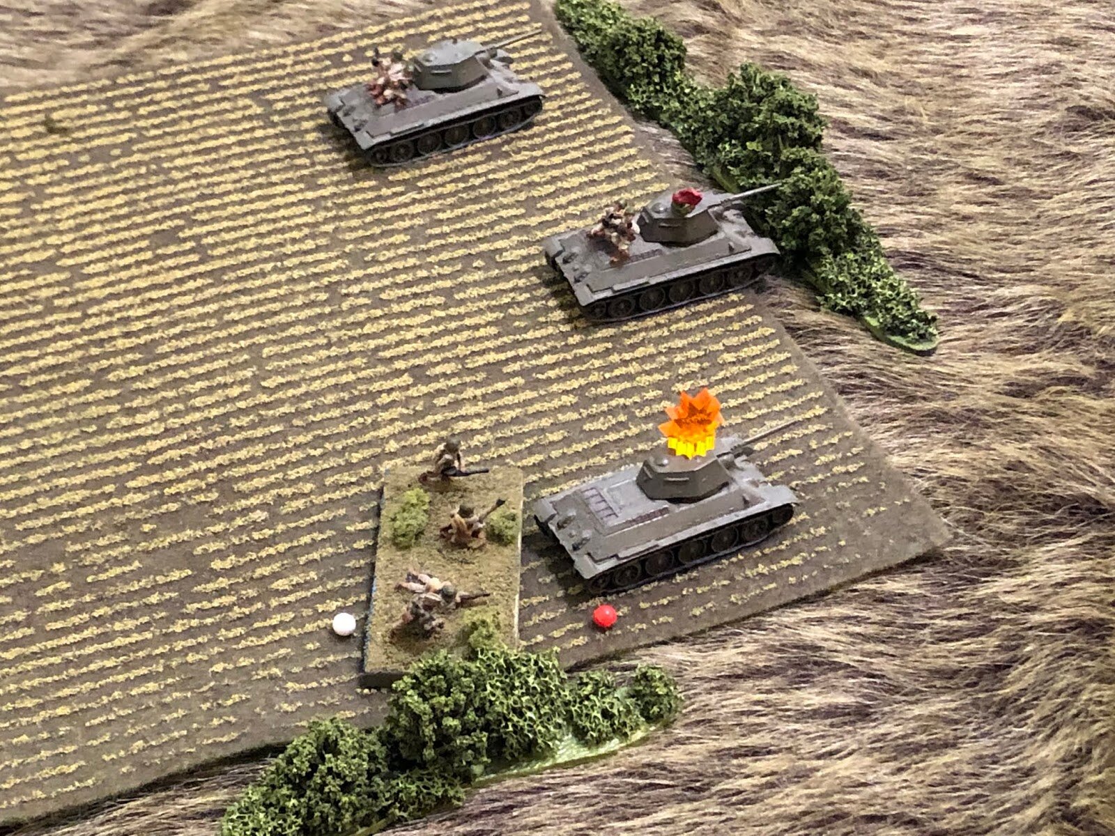  SHPLANGGG!!! The German round ricochets off the T-34, suppressing the crew and knocking off the tank riders, with casualties! The crew works on getting their stuff back together... 