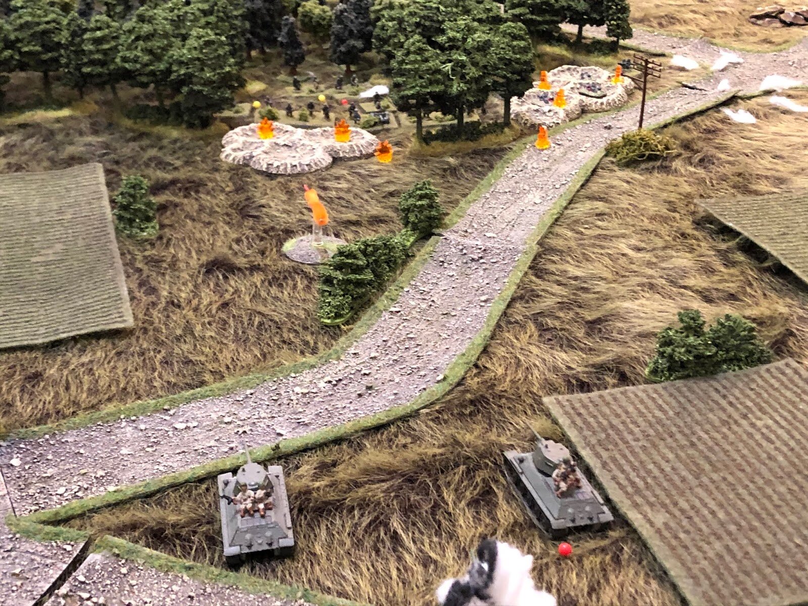  The two T-34s lay into the German defenders on the objective with their main guns.  