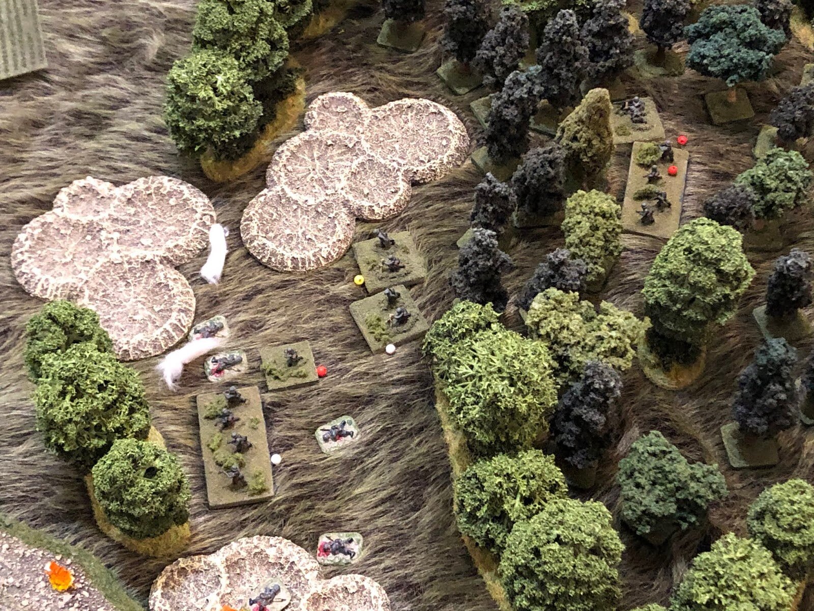  The fire is accurate and ferocious enough to put casualties on one of the mortar teams and force 3d Squad and the remaining MG team to fall back, suppressed (top right).  