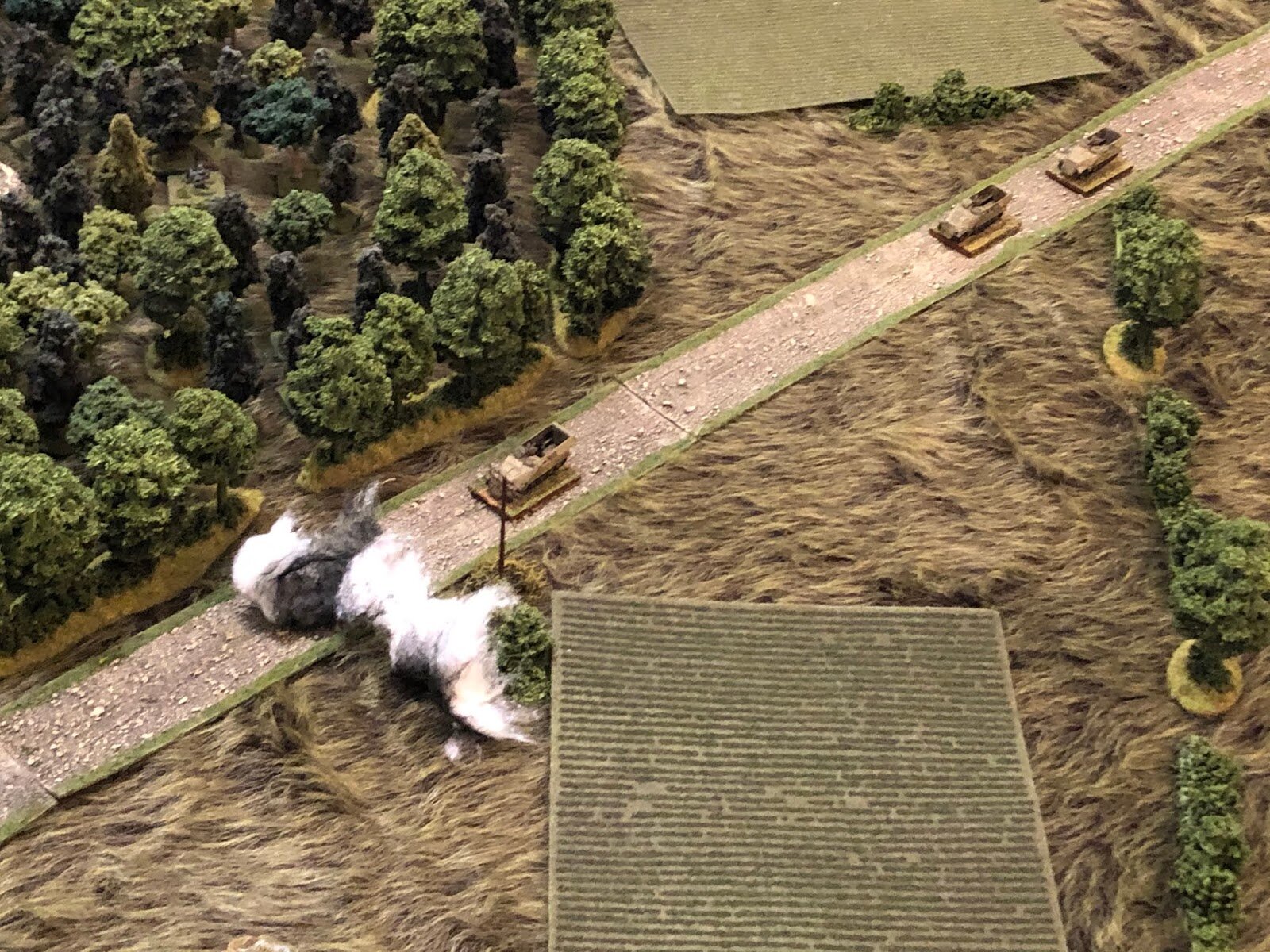  Dropping smoke on the road in order to obscure them from the German halftracks.  