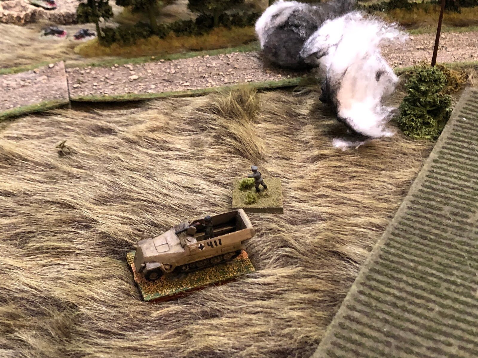  As the rifle platoon commander dismounts, looking to move towards the objective, where he expects his other two squads to head. Then it occurs to him that he's not sure why the rifle squad in the halftrack with him didn't dismount when he did... 