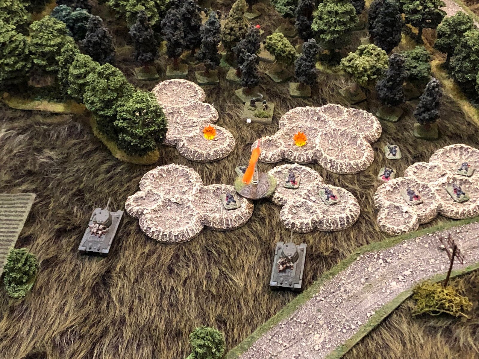  They open fire with their main guns and MGs at point blank range, but there's really no one left on the objective, they're all cowering deeper in the forest (top center). 