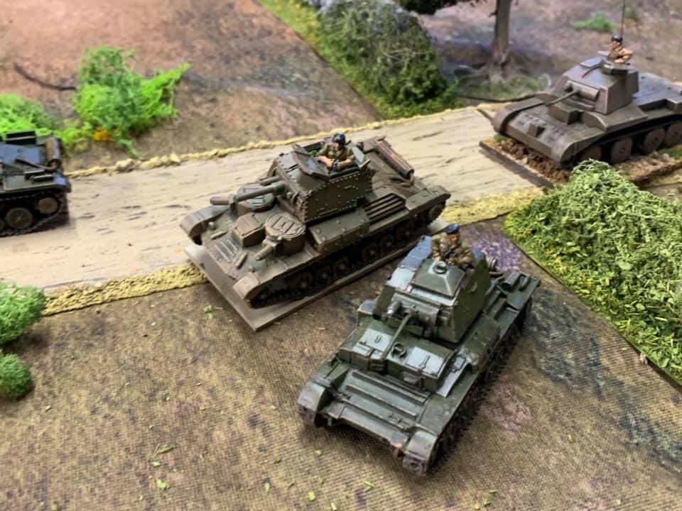  British armour attempting to deploy the road to enable them to tackle the German onslaught. Vehicles are a combination PSC A9, S Model A13 and A10 from Lancer Miniatures. 