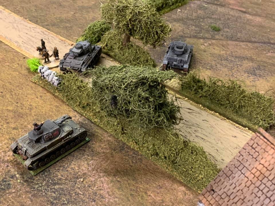  Panzers on the attack skirt the village. 