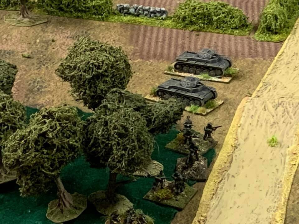  The German light tank section advances along their left flank. Sections of infantry an hour deploying along with their associated machine-gun teams. 