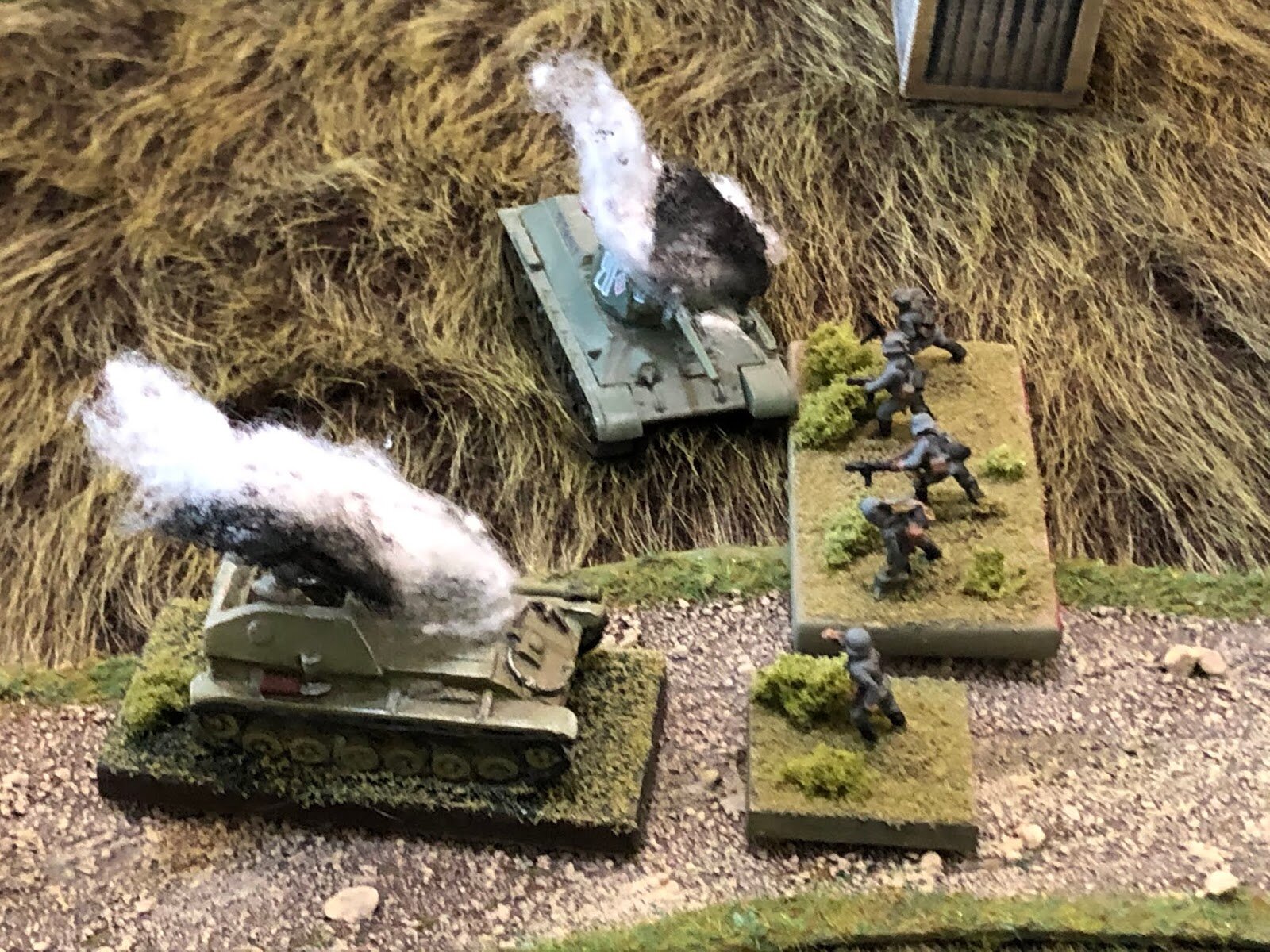  But the three-man crew in the open-topped Su-76 is no match for the hardened, veteran German infantry and is quickly belching flames and smoke of its own!   The German 3rd Platoon Commander gives a quick peek right... 