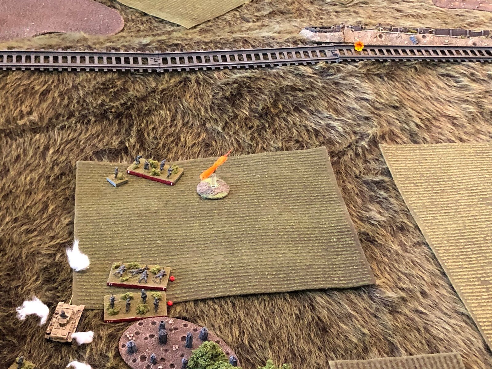  The German Panzer Platoon commander pushes his vehicle forward (bottom left) to support 2nd Company, and fires on the enemy railroad embankment position (top right)… 