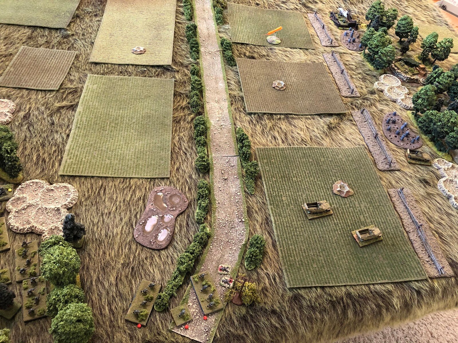  Unable to get their brothers from 1st Platoon, 1st Company (bottom center left, with 2nd Platoon at bottom left), moving, 3rd Platoon gets moving towards the southwest woods in their halftracks, with their PC getting through the gap in the wire (far