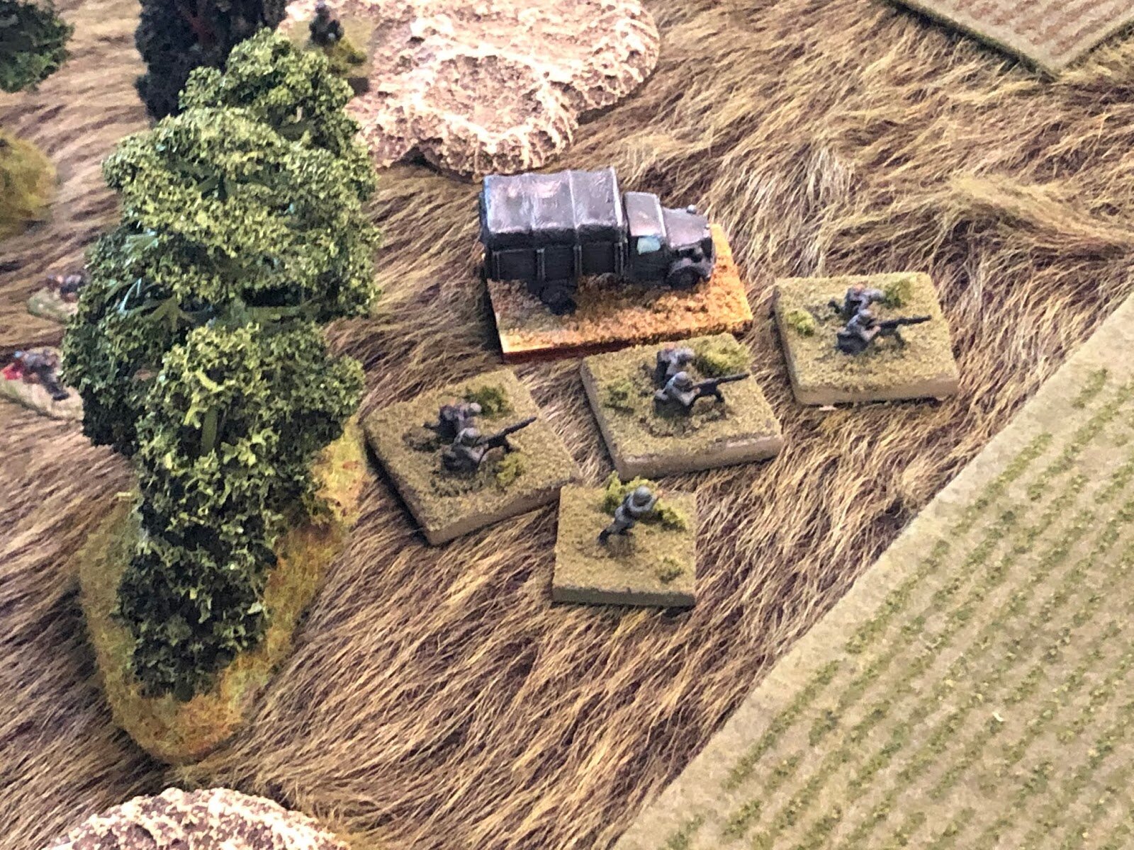  The German MG Plt loads up in its truck, ready to displace forward, up to the railway embankment.   *Yes, the Germans have not yet actually taken the southwest woods, but even they cannot help but note that they have received no fire from those posi