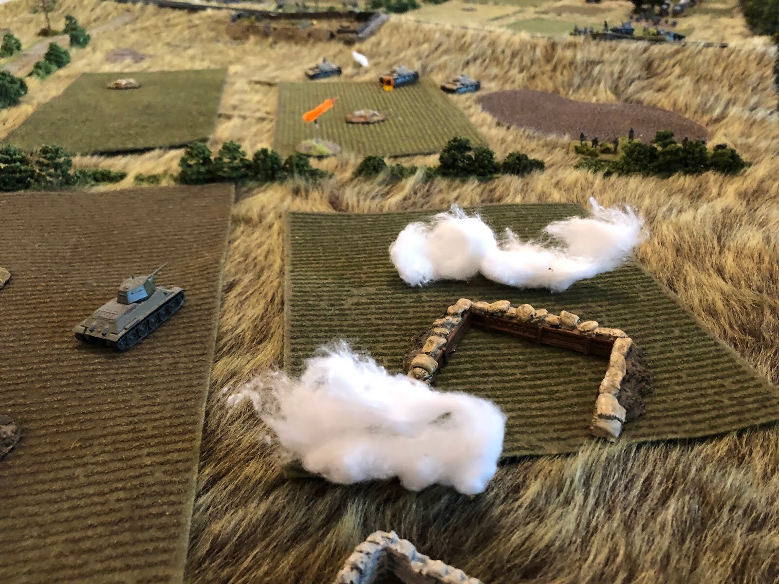  Meanwhile to his right , T-34 #2 has not spotted 2nd Platoon, 2nd Company (behind hedge at right top), but having smoke fall all over them has convinced that something might just be up, so they reverse out of their dug out, pull left (far left), the