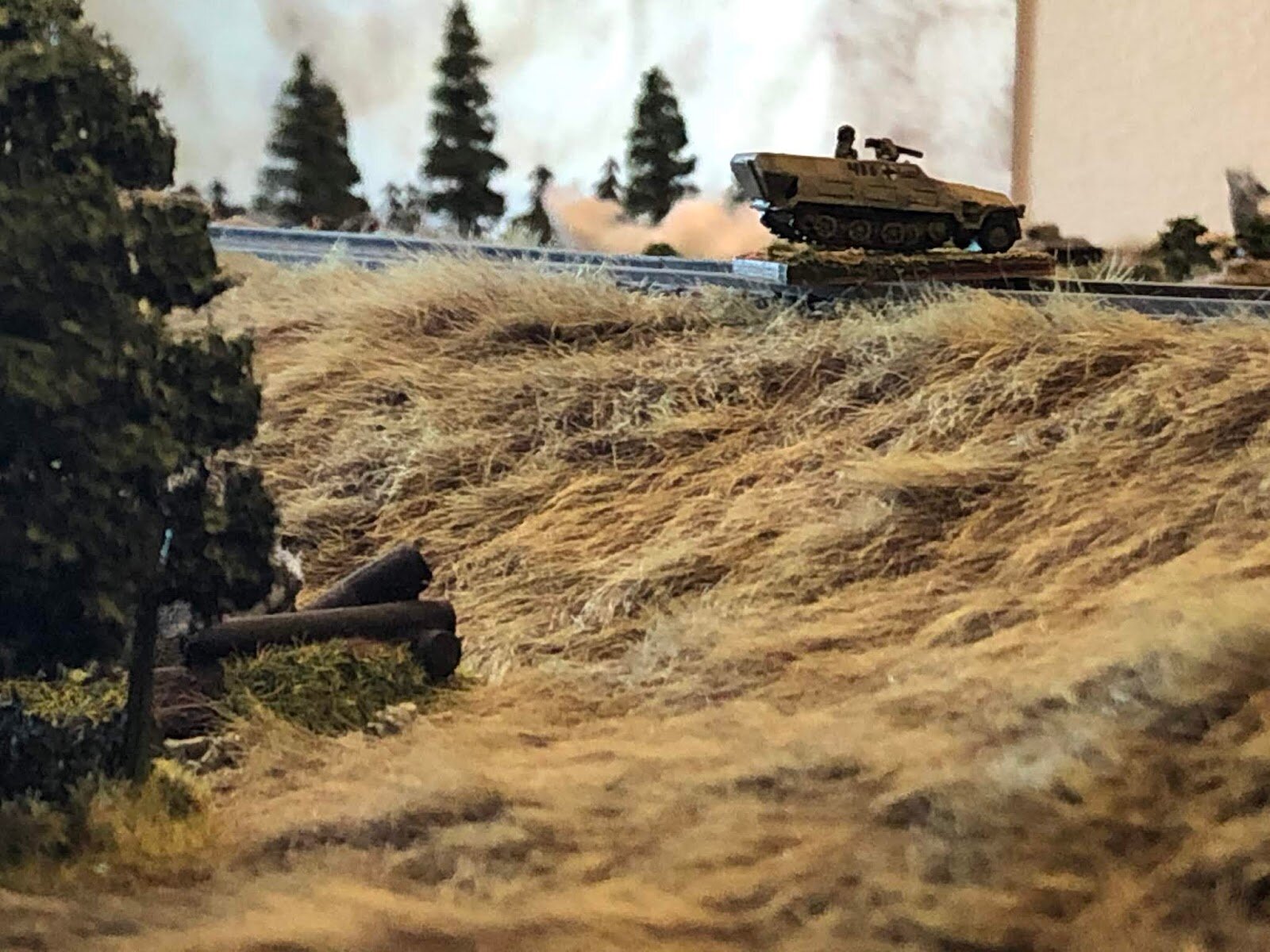  Having lost track of the Soviet infantry on the right (the Soviet 1st Rifle platoon remnants were just off camera to the right, last time he saw and fired on them), the German Halftrack Platoon Commander pushes his vehicle forward, cresting the rail