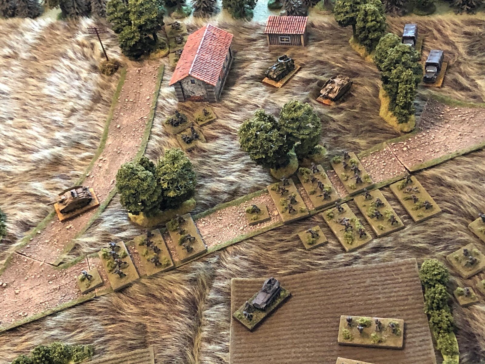The German 1st Company is moving in fits and starts, experiencing a traffic jam on the road, as the lead Stug, the Platoon Commander's vehicle, pushes ahead (far left, from top center).