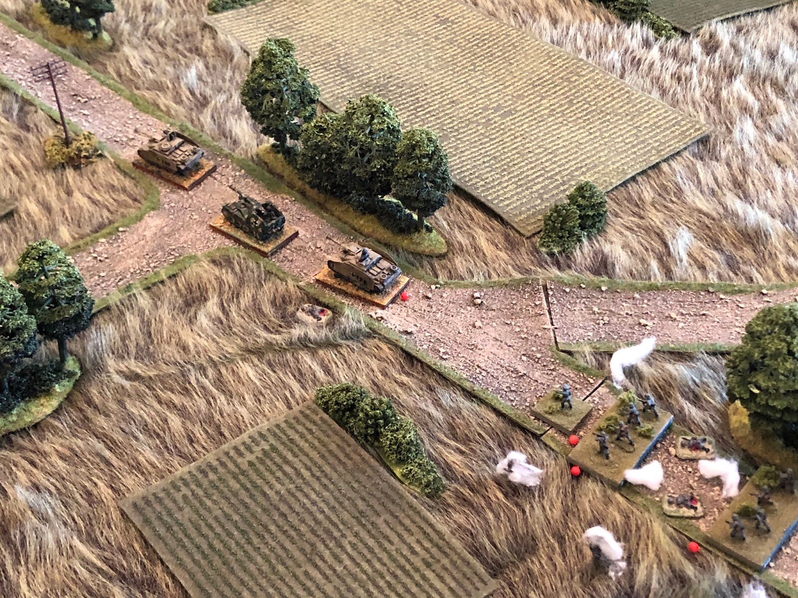 Back on the road, Stug #2 and the Marder are unable to get the platoon commander's vehicle to rally, so they push past the stalled out vehicle (top left).