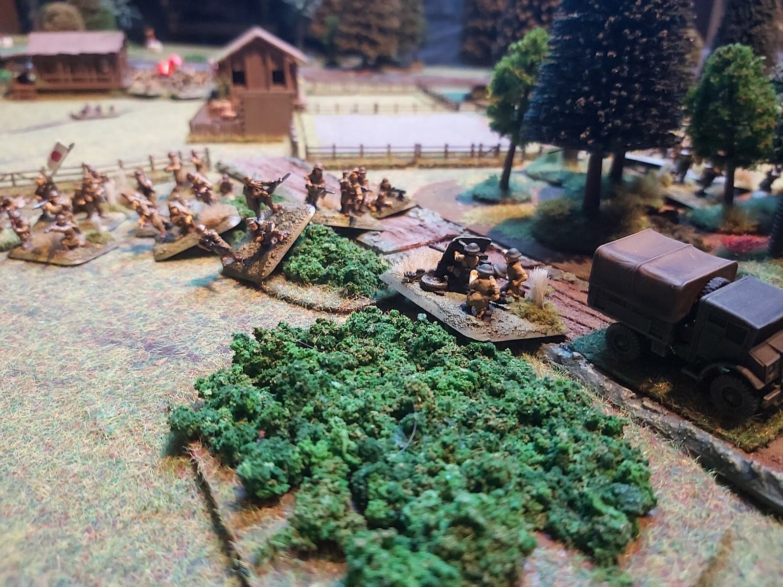 Passing through the village some of the Japanese soldiers smash into the 2 pounders who are caught in the open!