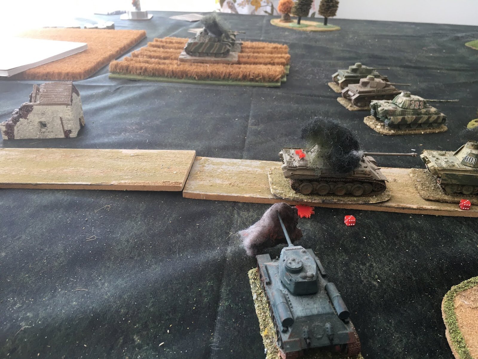 Flushed with success, a T-34 emerges from the woods and hits another German tank with flank fire