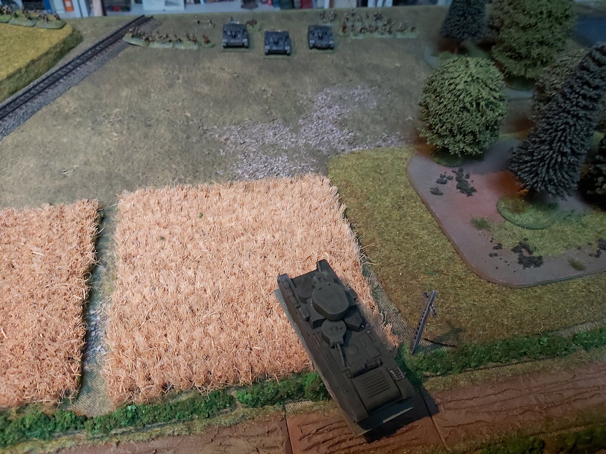 Smashing through the hedge and into the fields one of the T-35s opened fire on the StuGs. Although it hit it only caused minor damage.