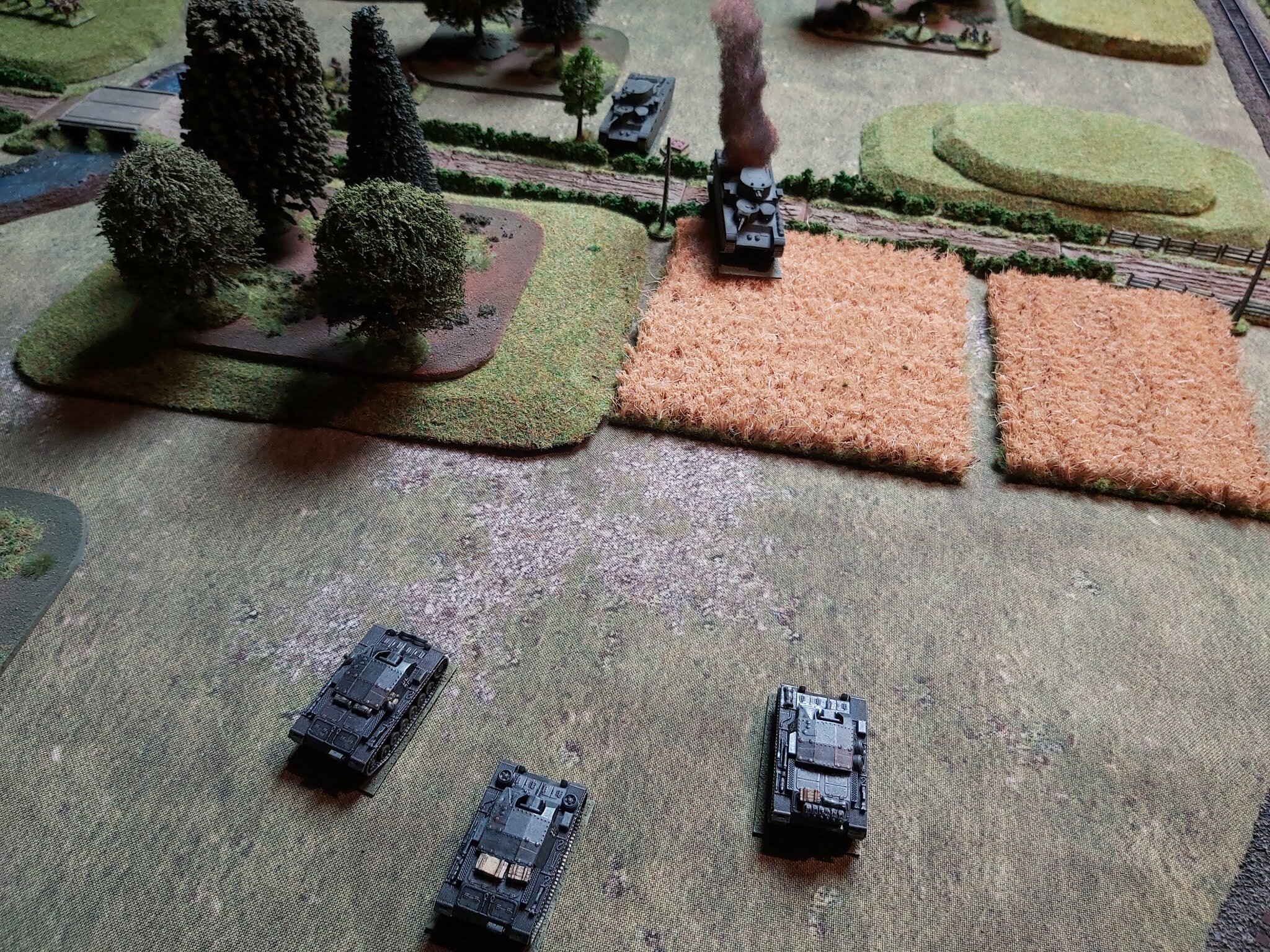 Over on the other flank, the StuGs opened their engines and guns, immediately taking out the leading T-35 and knocking out the main gun of the second one!