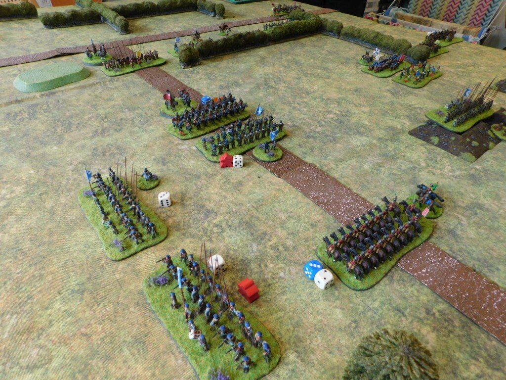 The infantry battalia on the left have taken advantage of their secure flanks to drive back the Royalist horse sweeping in from the east.