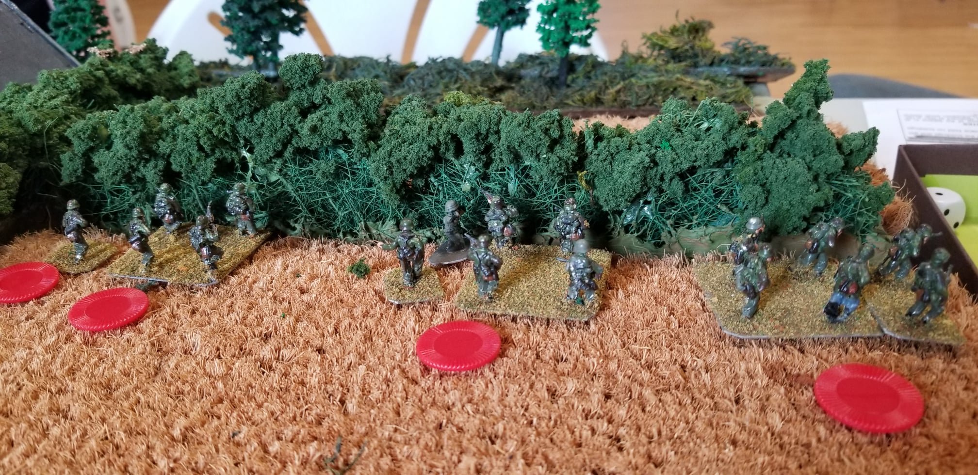 Three squads of Germans overwhelm a single Canadian squad behind the bocage but suffer shock and 7 kills.
