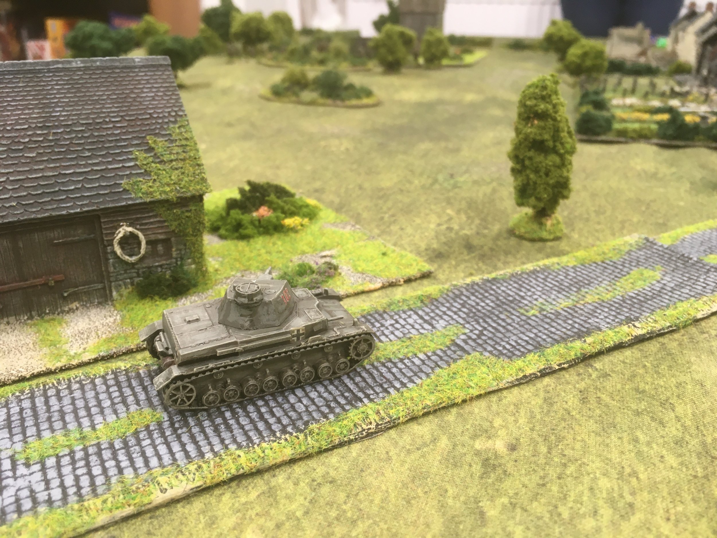 Advancing towards the village, the German tank looses off a couple of rounds at the French on the hill...