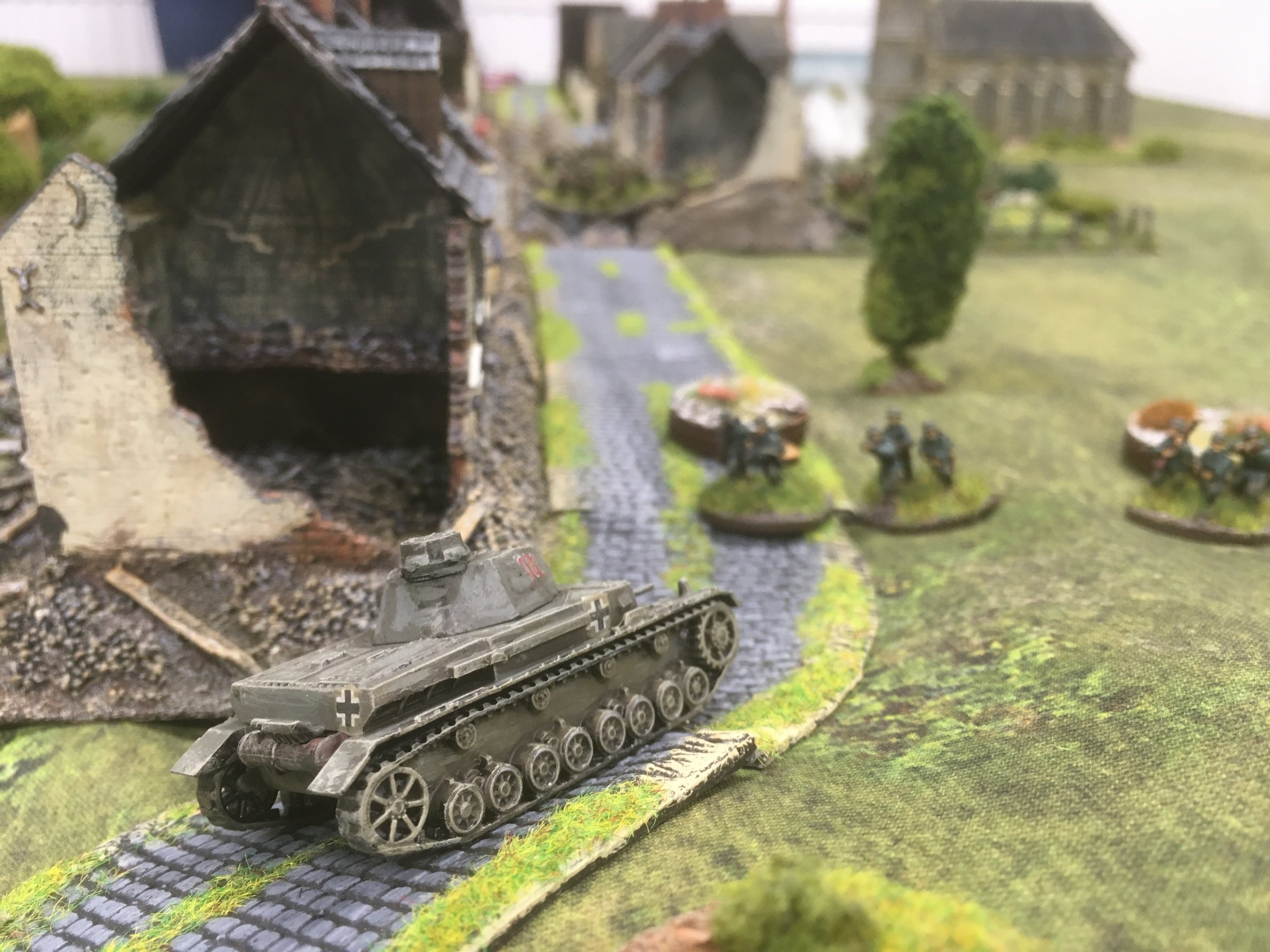 As the motorcycle troops attempt to pull themselves together, the PzIV moves around the corner and spots the French infantry in ruins of Stonne.