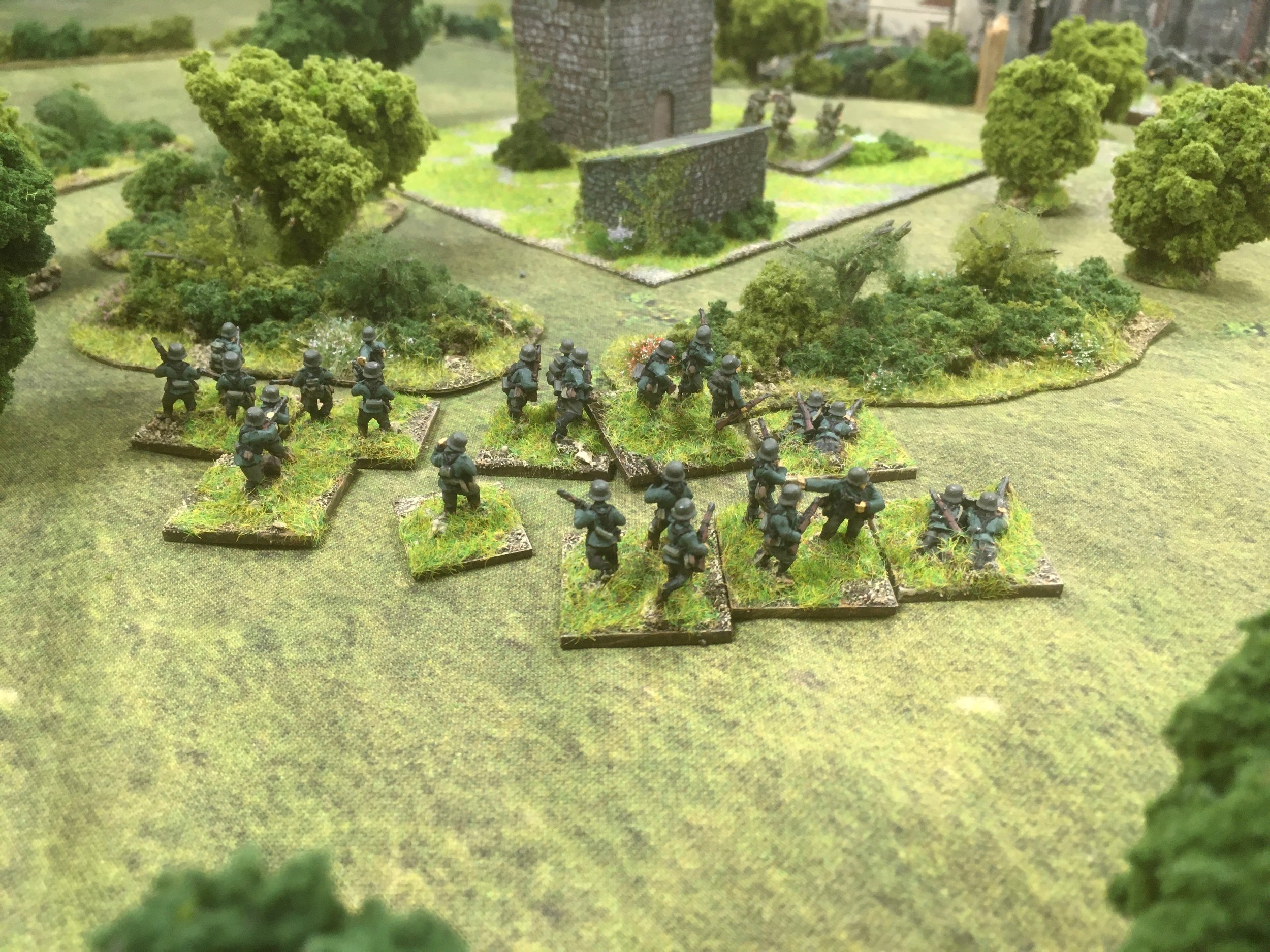 The third disembark their lorry and advance into the wood.