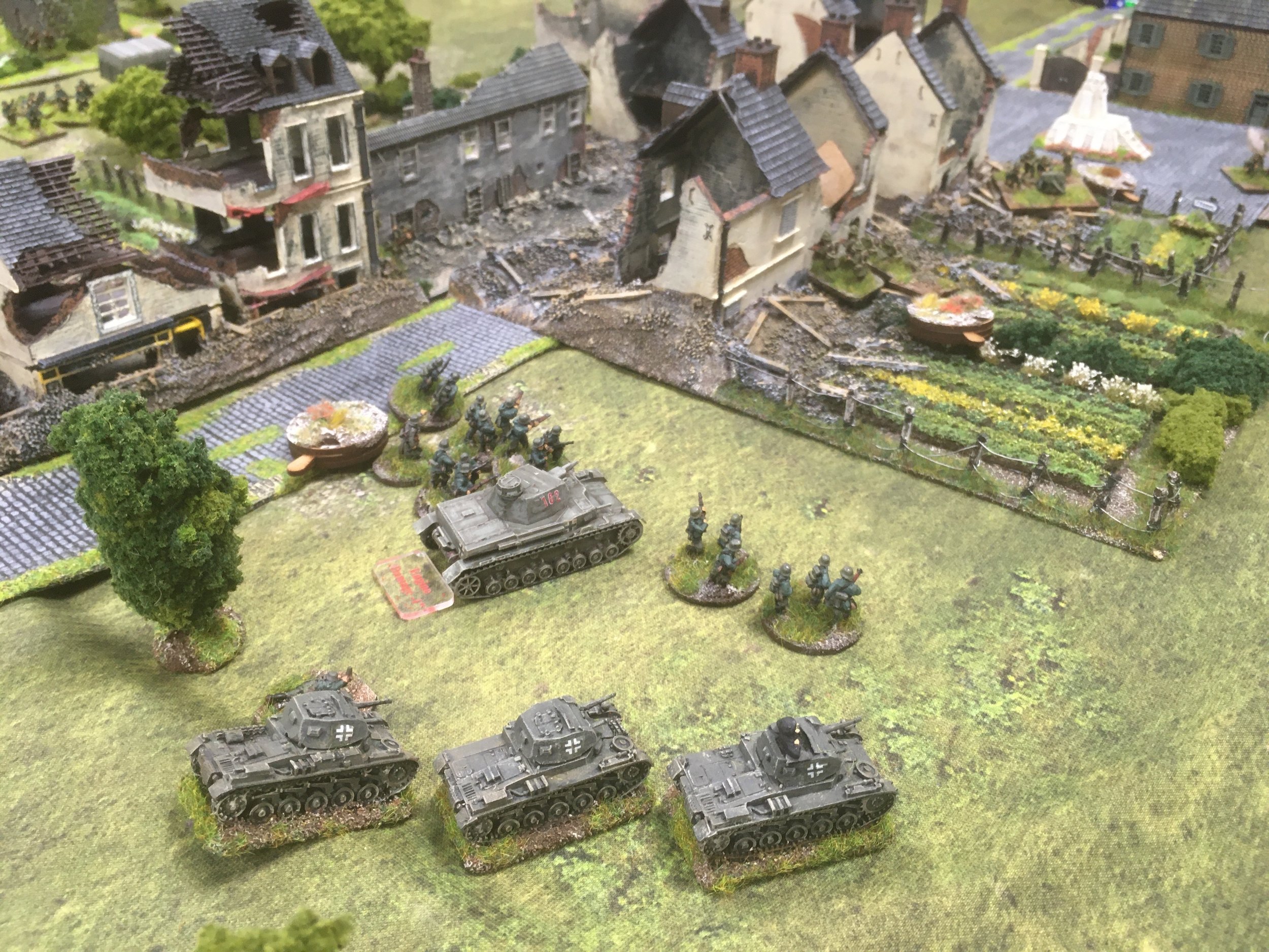 In the centre the slowly moving Panzer IV, now supported by the dismounted motorcycle platoon and Panzer II platoon engage the French infantry and surviving Hotchkiss anti-tank gun.
