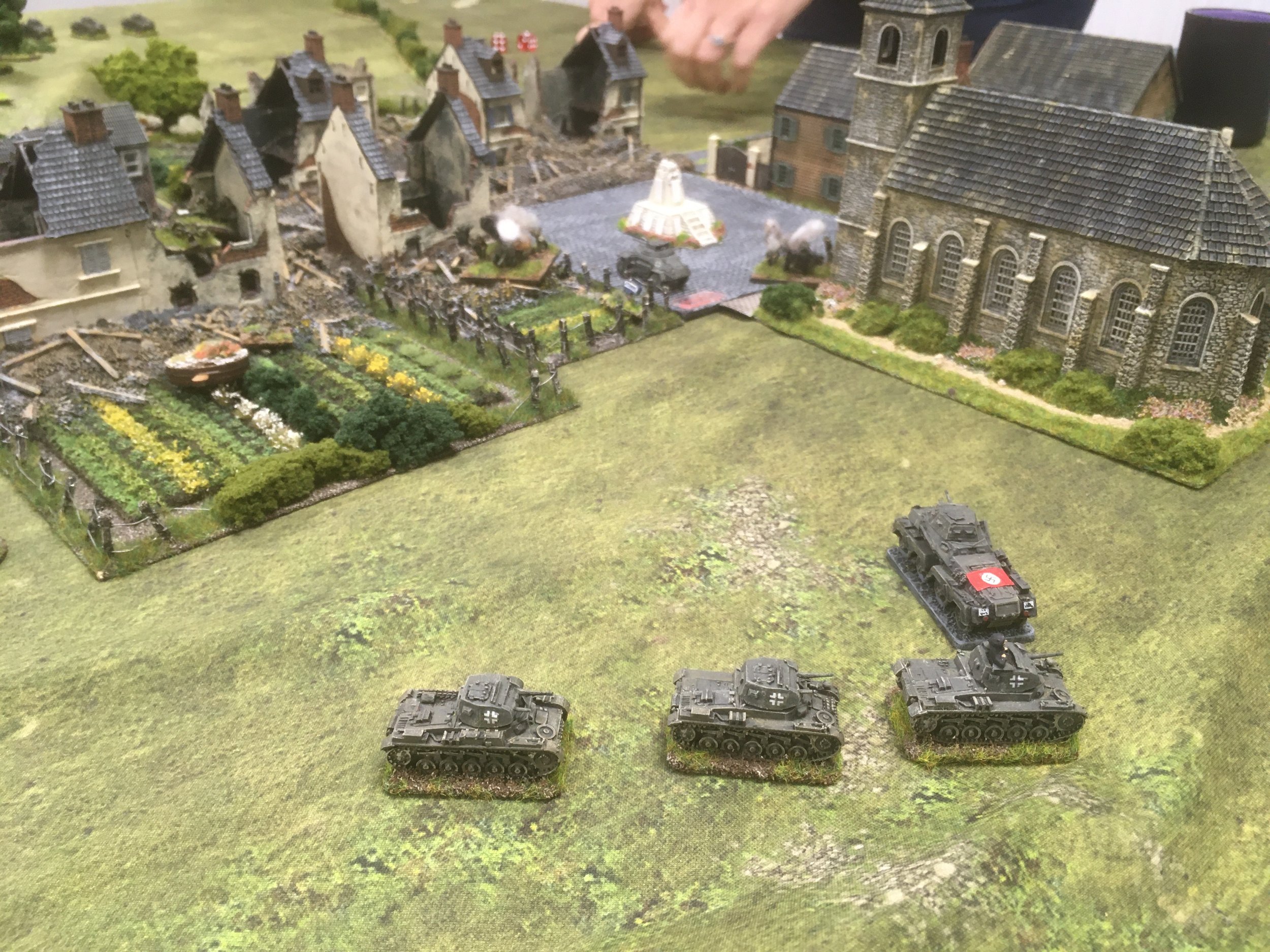 Meanwhile, as the sun begins to set, the Panzer II's sweep around the village passing the Sd.Kfz 231. 