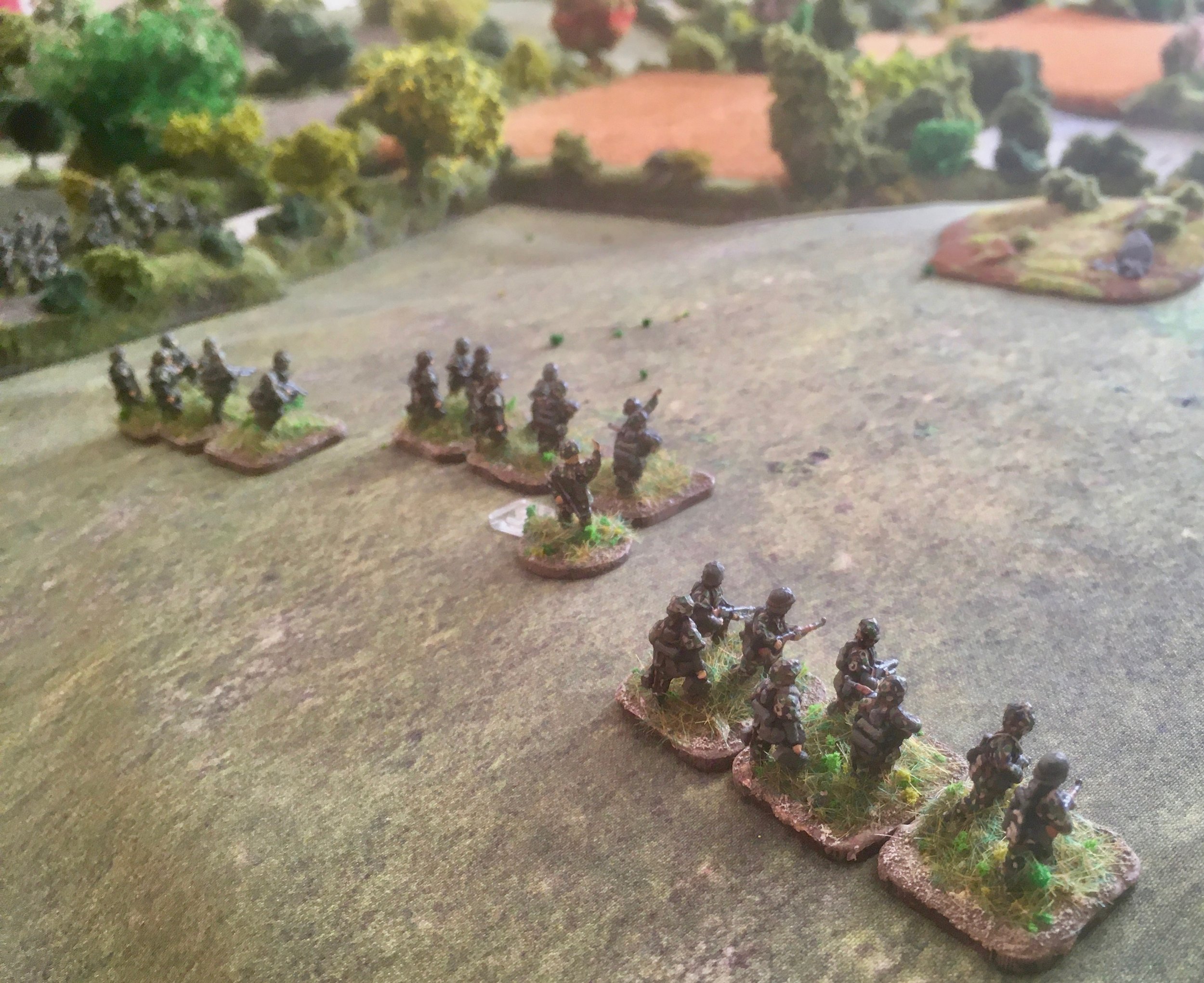 One platoon moving as quickly as possible over the exposed Normandy fields.