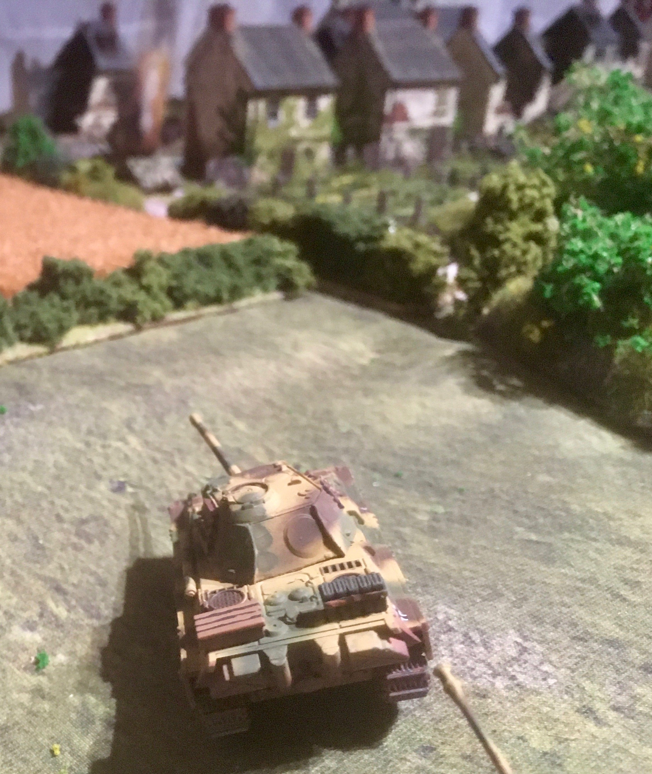 The Panther then moved forward and loosed a shot at the British armour on the village outskirts...