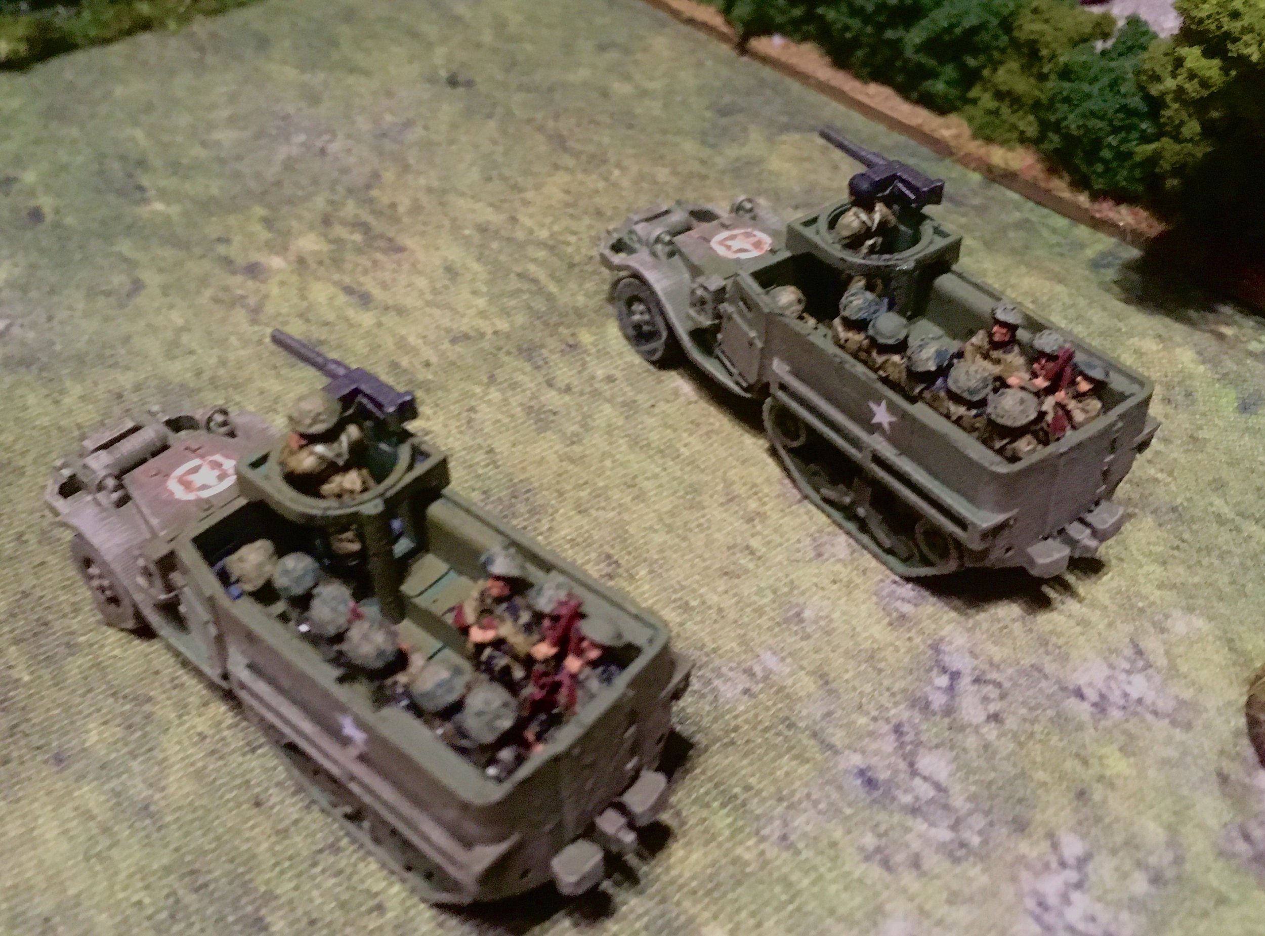 The German commander training list 20mm AA cannon on the second platoon of Grenadier Guards in their M5 half-tracks.