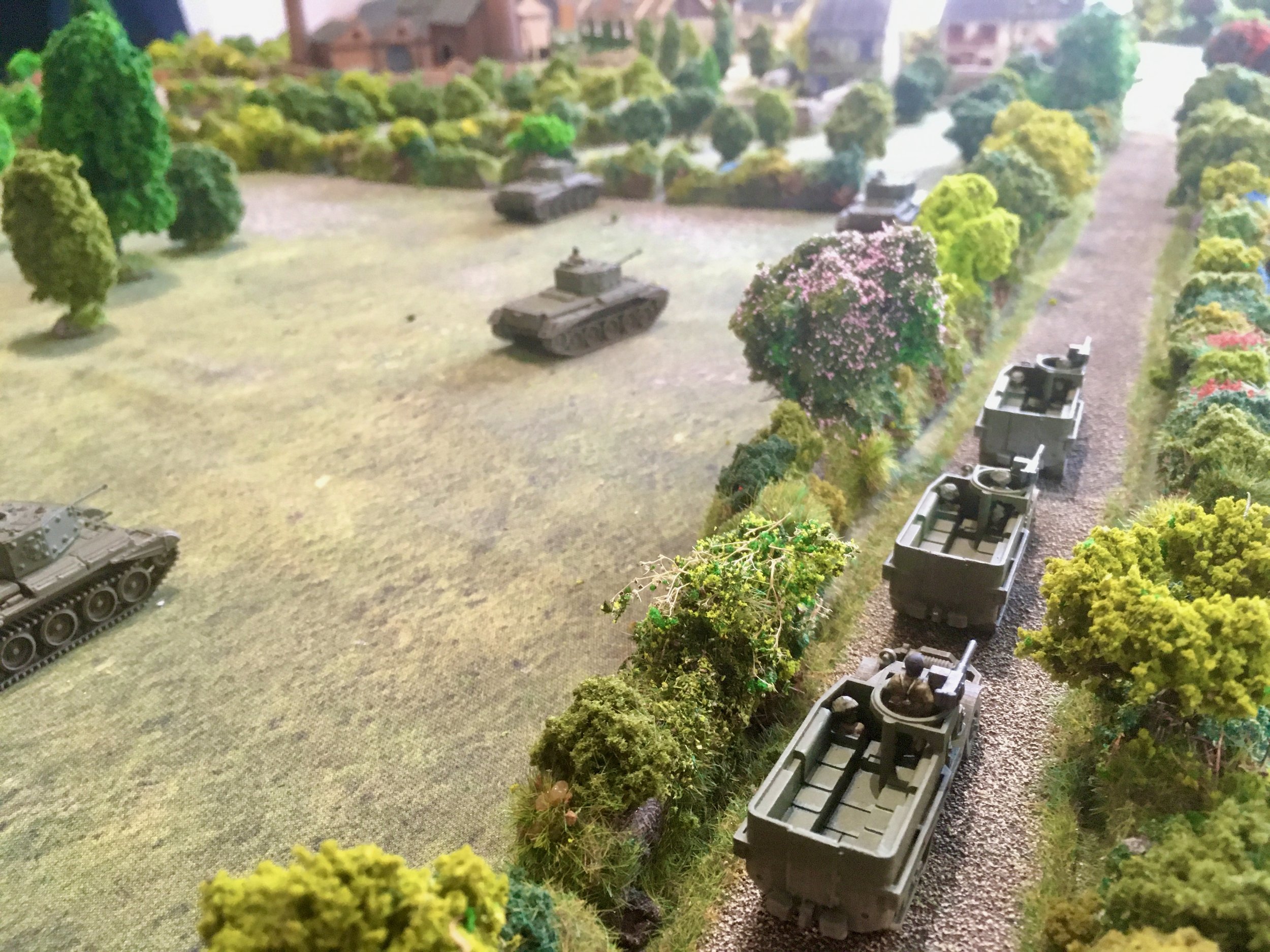 With one platoon of infantry accompanying the armour, a second advances parallel along one of the two roads leading into the village.