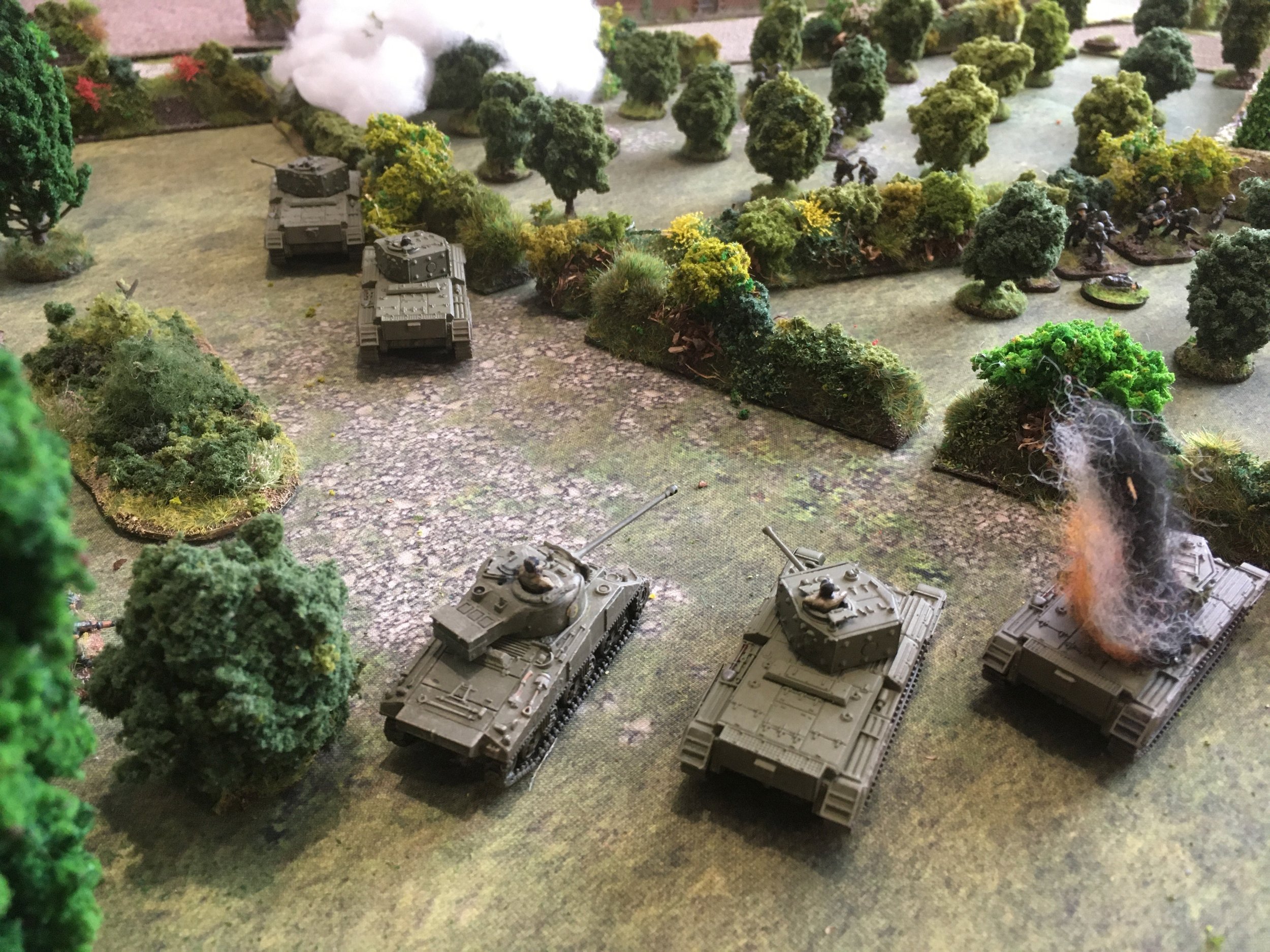 Using the smoke as cover, 2 Troop pushed their Cromwells forward past the burning 1 Troop.