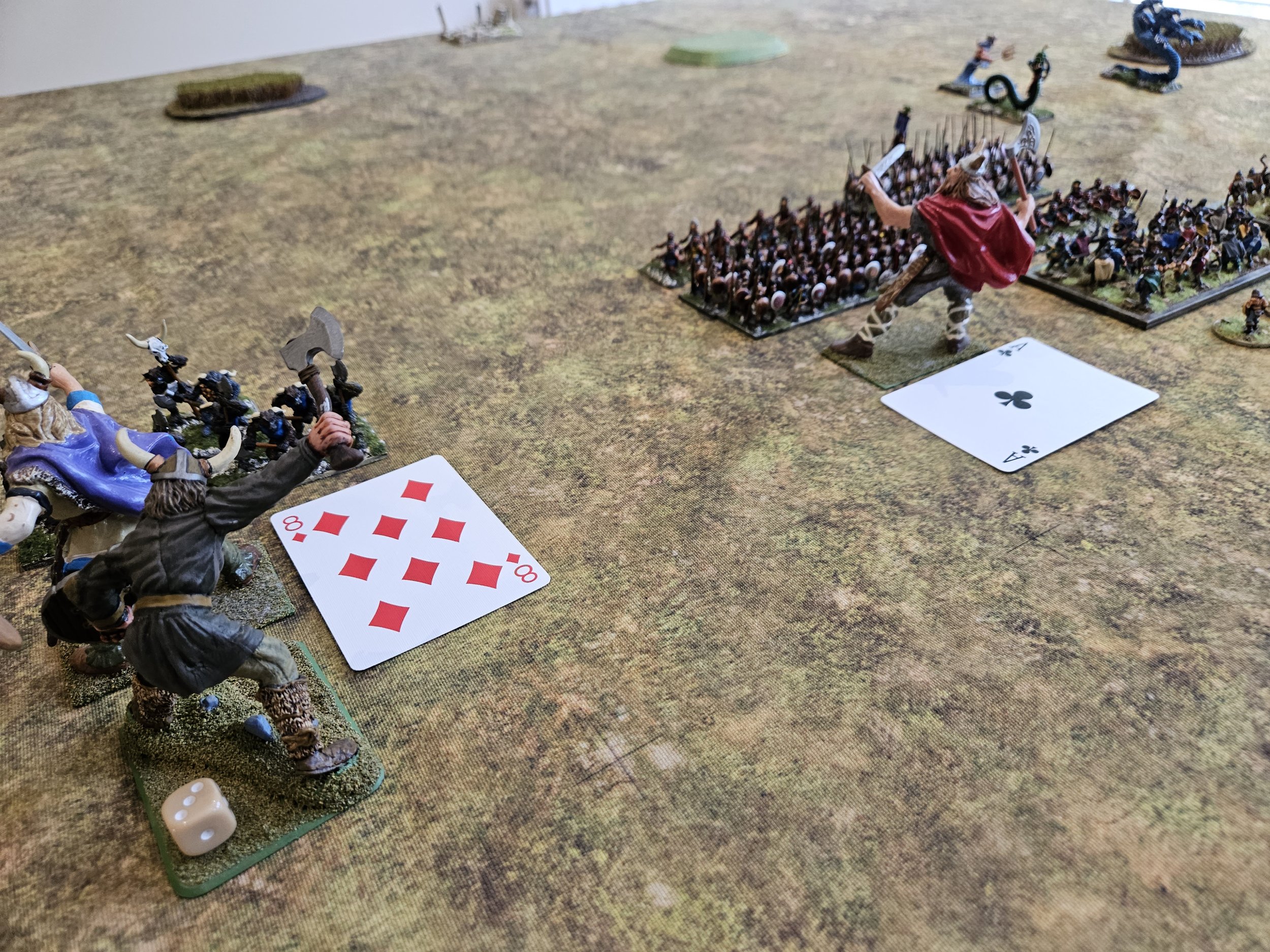  It’s the Norse turn two now, and the Jotun in the red cloak has drawn an ‘Ace’ for activation. Not a problem: the Jotun Officer/Shaman send s a magic point his way… 