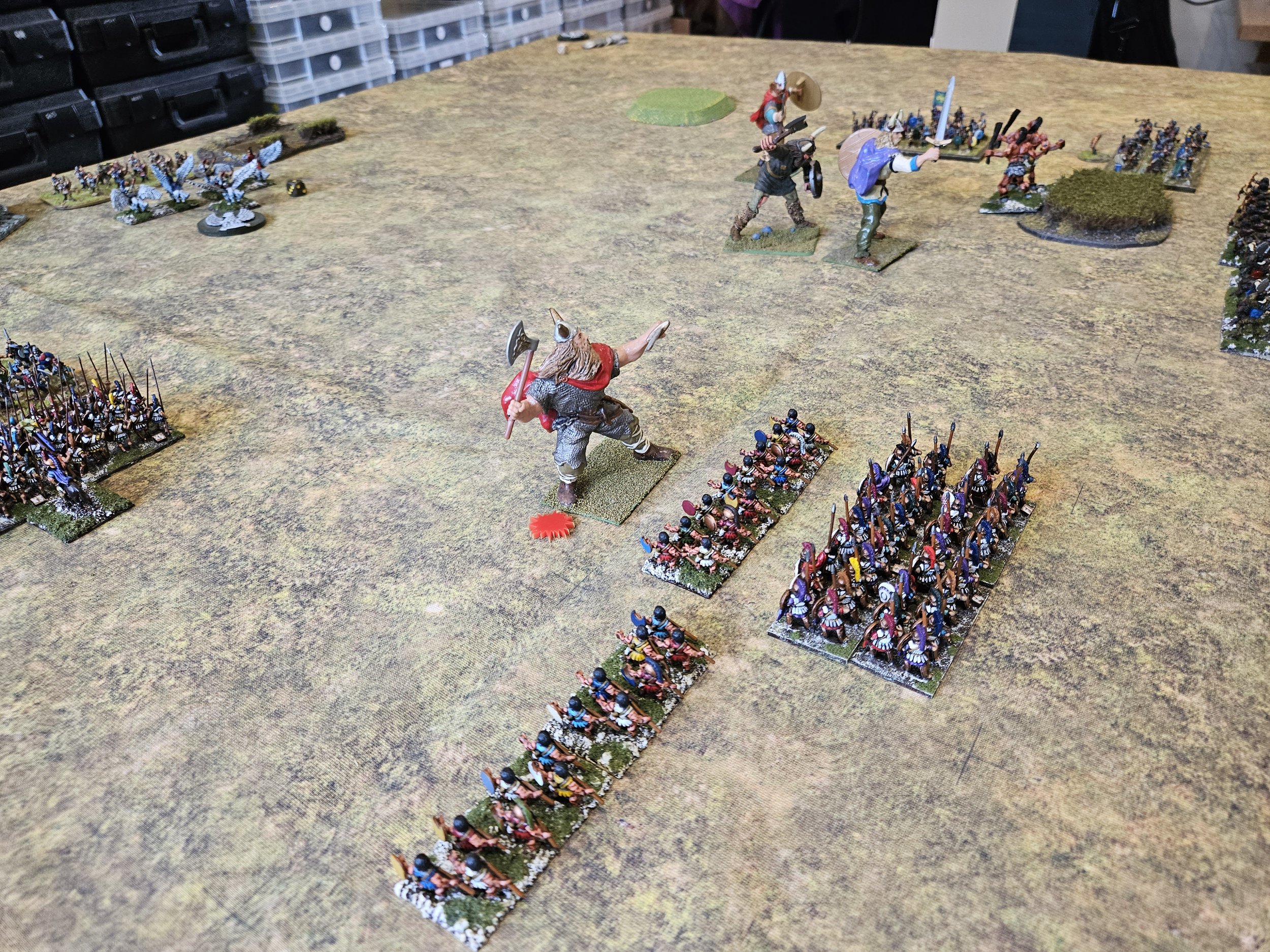  In the centre, helped by Poseidon, who now has some magic points back, the Hoplites have rallied and, aided by the psiloi, have started to fight back against the Jotun in the red cloak (who has just been hit by javelins from the lights). 
