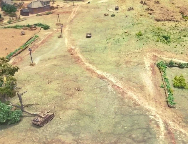A pair of StuGs advance overwatched by commander