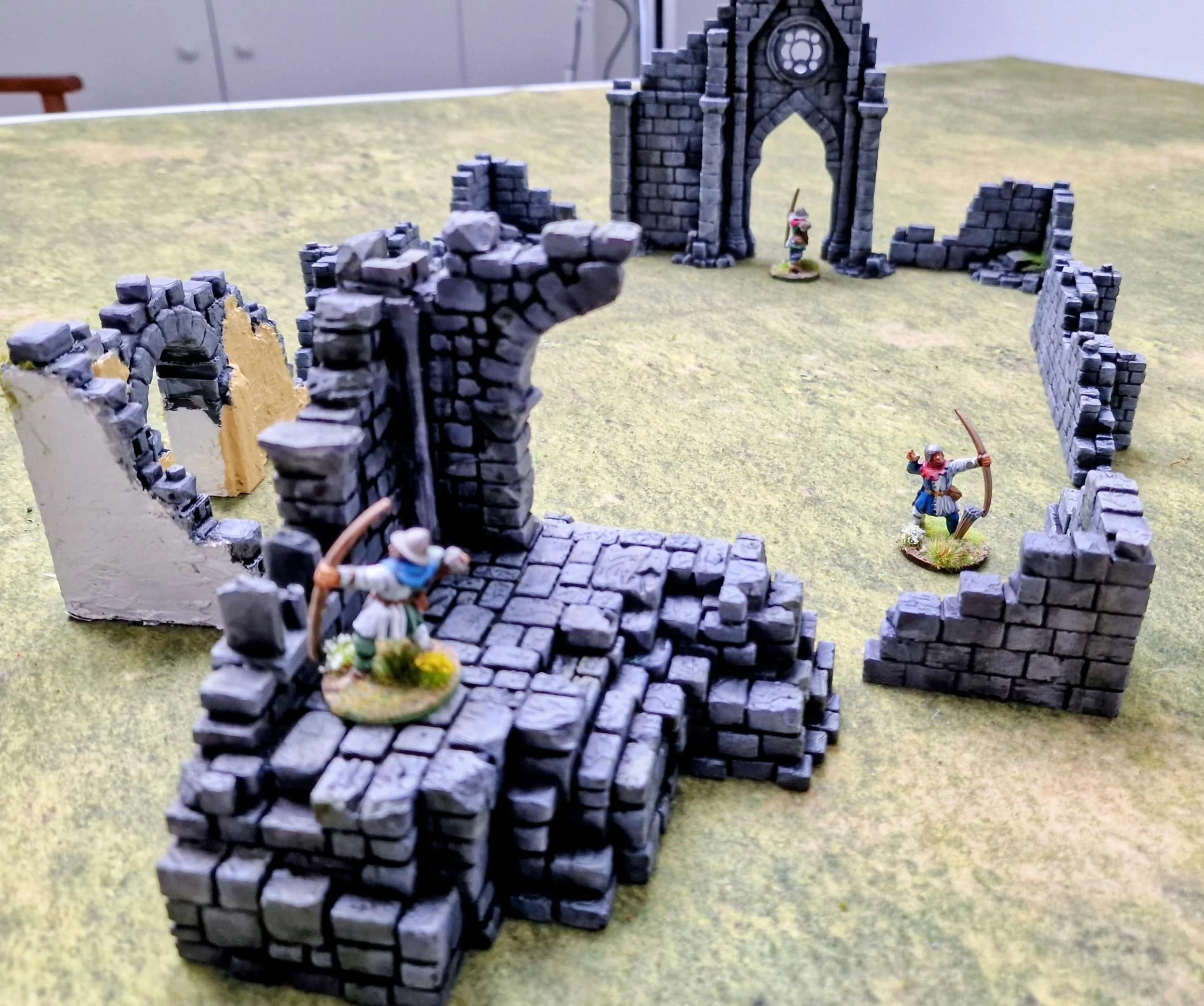  All the newly printed terrain on my table with some old Games Workshop archers. 