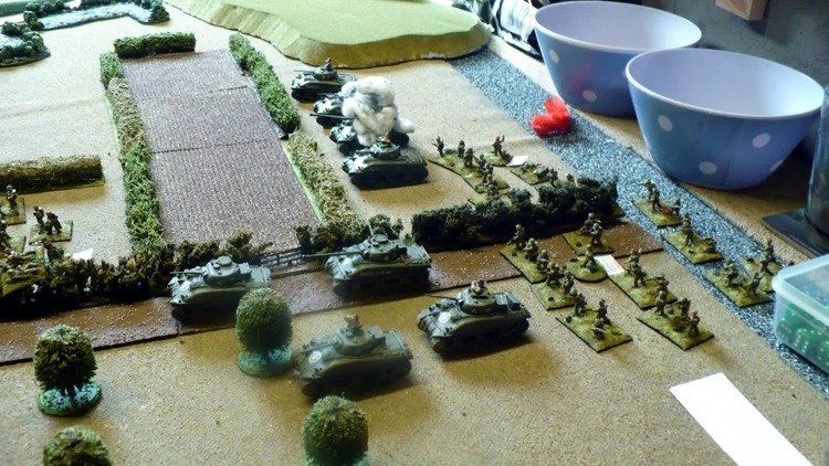Canadians deployed with Shermans burning already