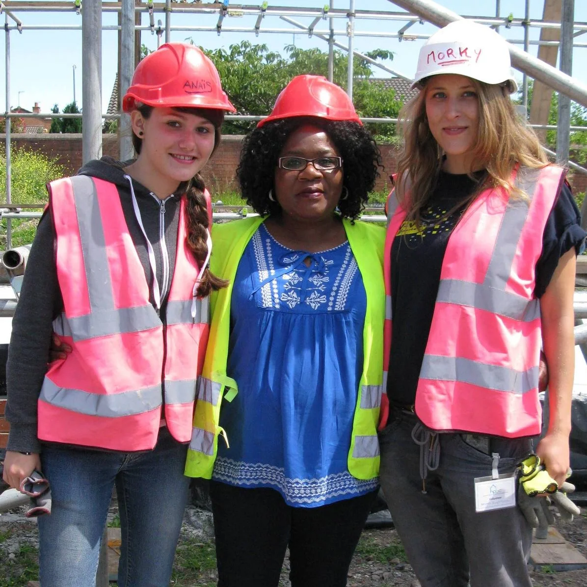 HPBC’s homes are built largely by volunteers, including the home partners themselves. Home partner Joyce Msiska (ctr) with two French students currently volunteering on site, Anais Lameira (left) and Angelique Brouard.