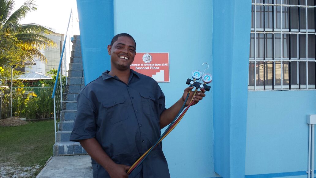 Bowen displays the refrigeration equipment he was able to purchase with a grant from the Pan American Development Foundation (PADF).