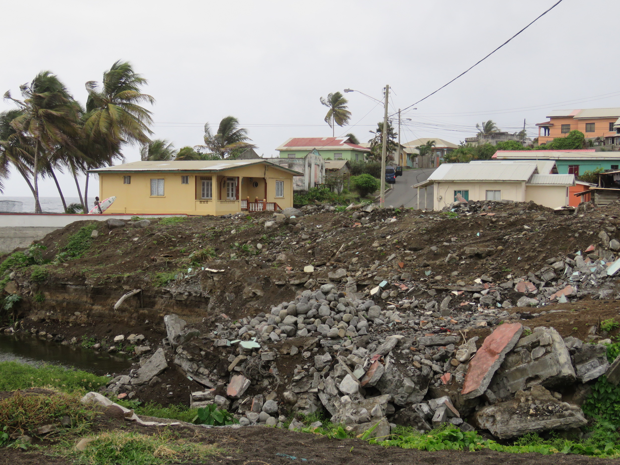 Rubble marks the spot where a house collapsed into the riverbank during the 2013 floods in Natalia’s neighborhood of Georgetown.