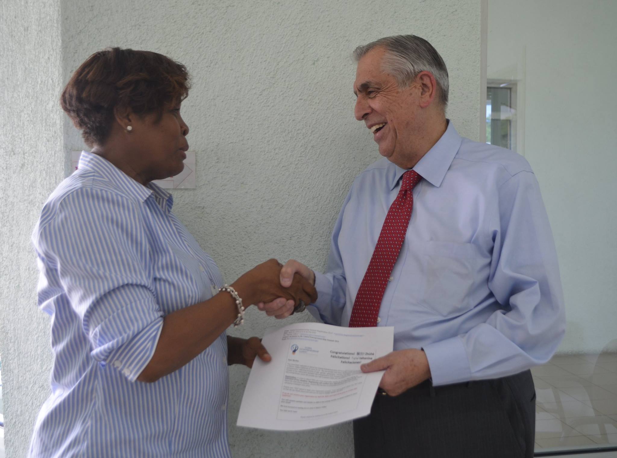 PADF Executive Director John Sanbrailo wishes Myrtha Vilbon good luck before she heads off to the Global Entreprensur Summit.