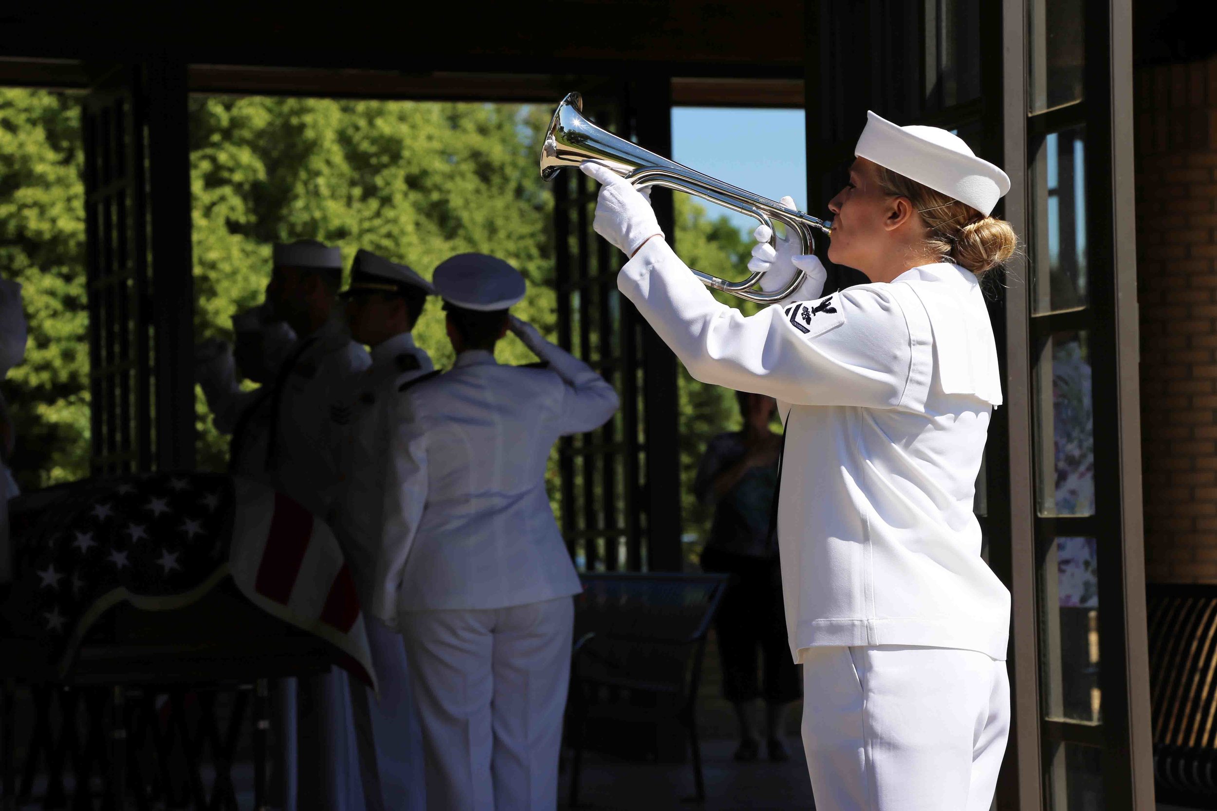 A member of the Navy Honor Guard plays taps. Photo courtesy of Erick Stowe. 