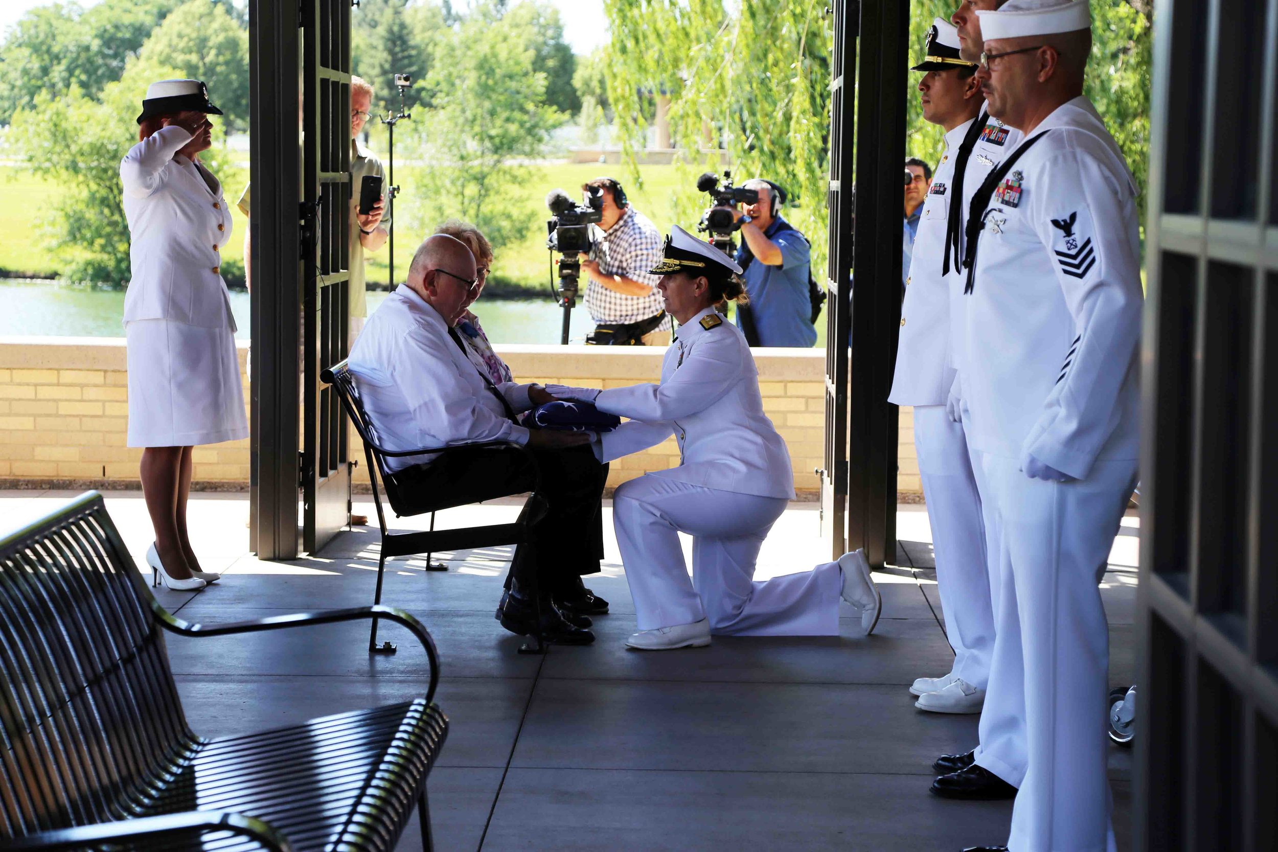 Rear Admiral Jackie McClellan presents a folded flag to Wallace Eakes’ nephew, Gary Eakes. Photo courtesy of Erick Stowe. 