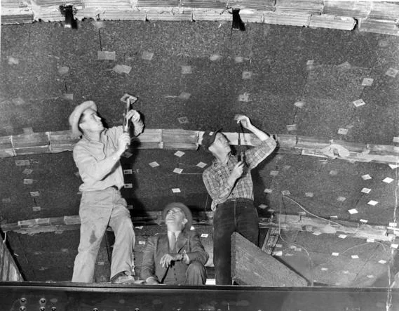 President Truman looks on as Workmen install Cork Insulation to the White House Ceiling 