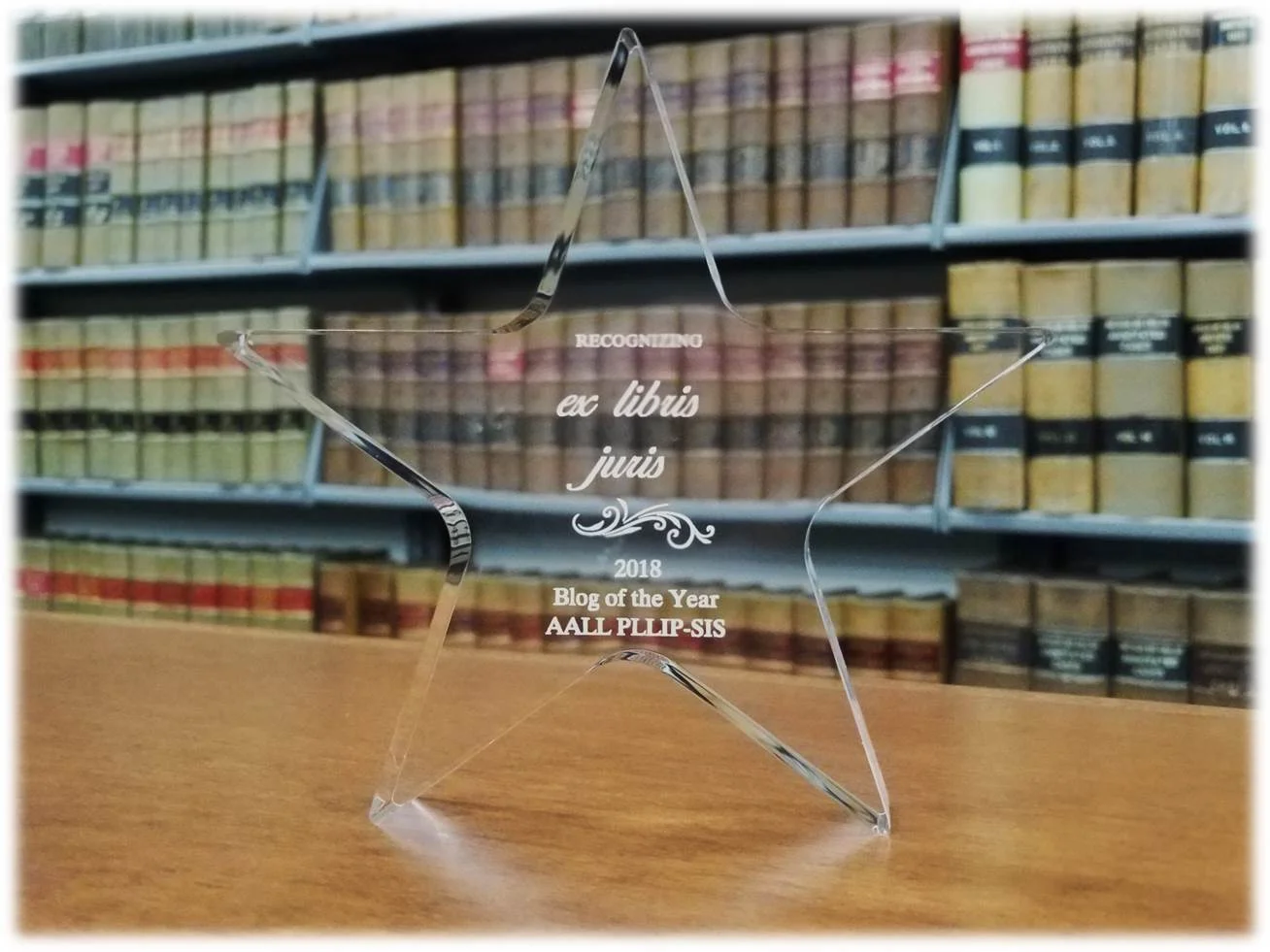 Acrylic star in front of bookcase inscribed, "Recognizing ex libris juris, 2018 Blog of the Year AALL PLLIP-SIS
