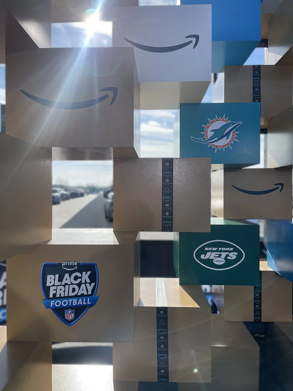Primate Studio Amazon Prime Black Friday close up view of scenery imitating stacked amazon boxes with branding of football teams