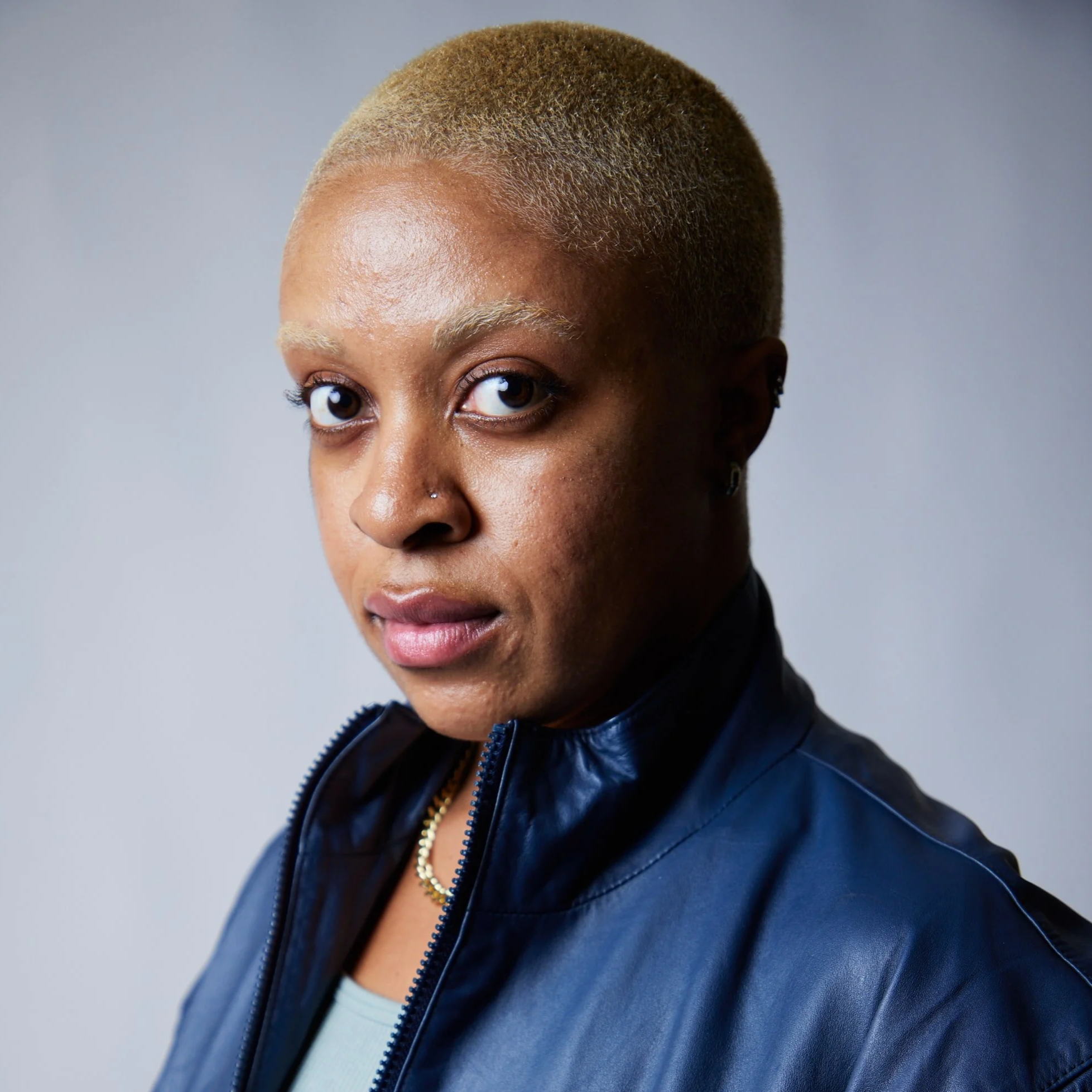 image of Ziggy with short cropped hair and blue leather jacket